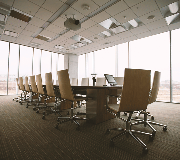 Conference room with floor-to-ceiling windows and office chairs.