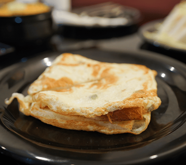 A plate of egg omelette on toast.