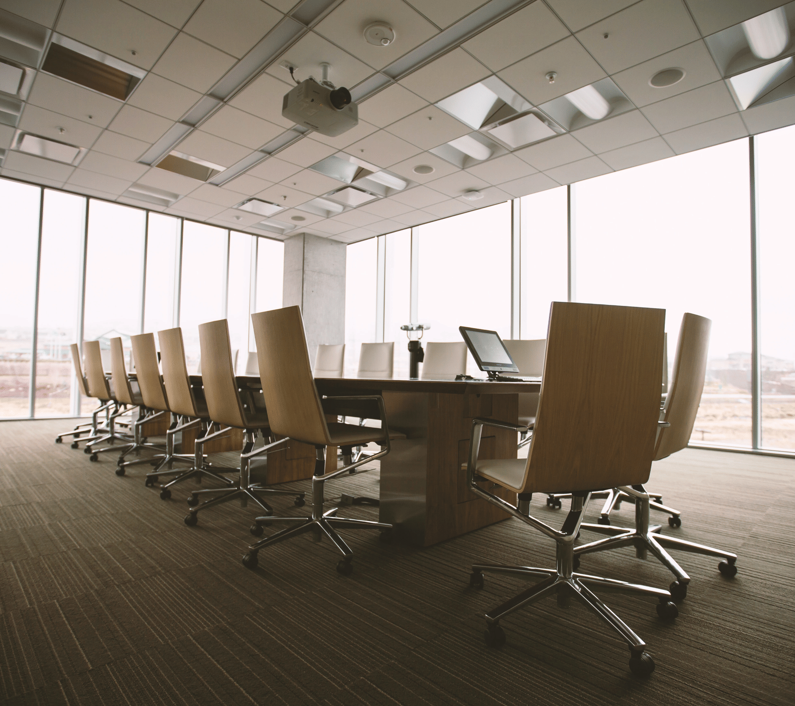 Conference room with floor-to-ceiling windows and office chairs.