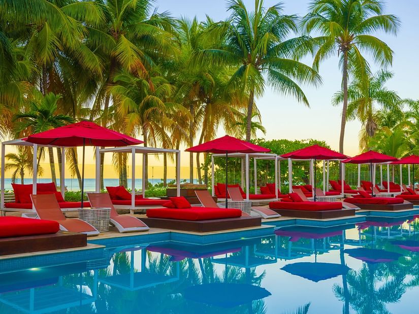 A close up of our pool in Montego Bay with red sun loungers on the deck - S Hotel Montego Bay, Jamaica