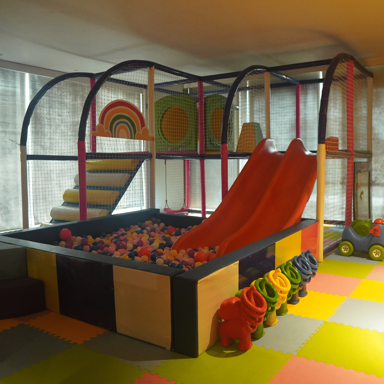 Kids play area featuring slides and a ball pit.