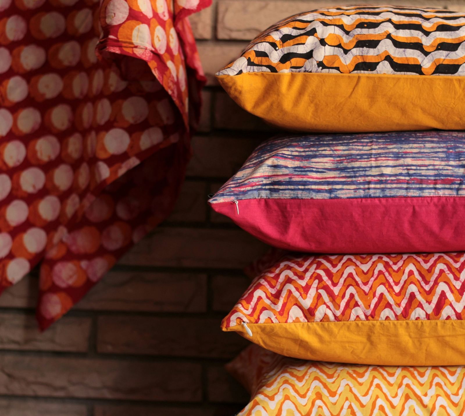 Vibrant stack of colourful traditional Indian cushions and textiles