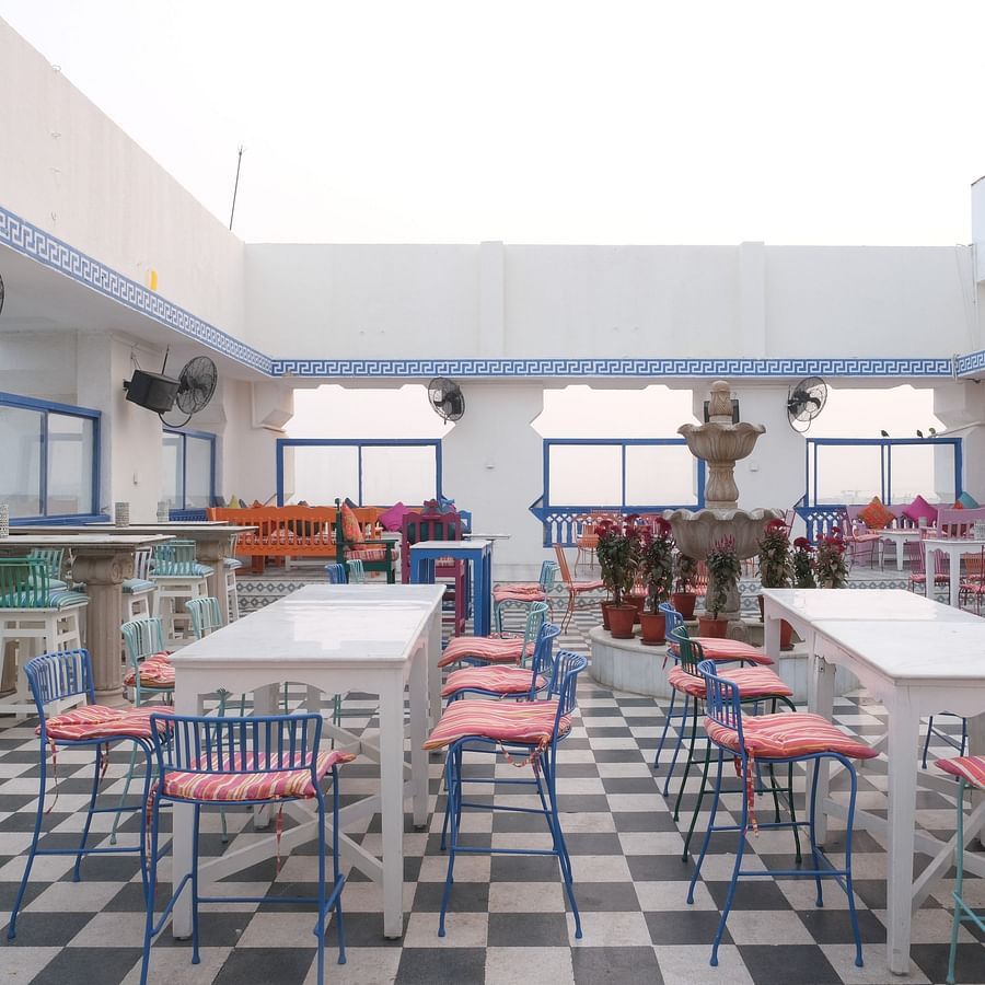 The elegant seating area of ta BLU Rooftop Bar at Clarks Amer, Jaipur