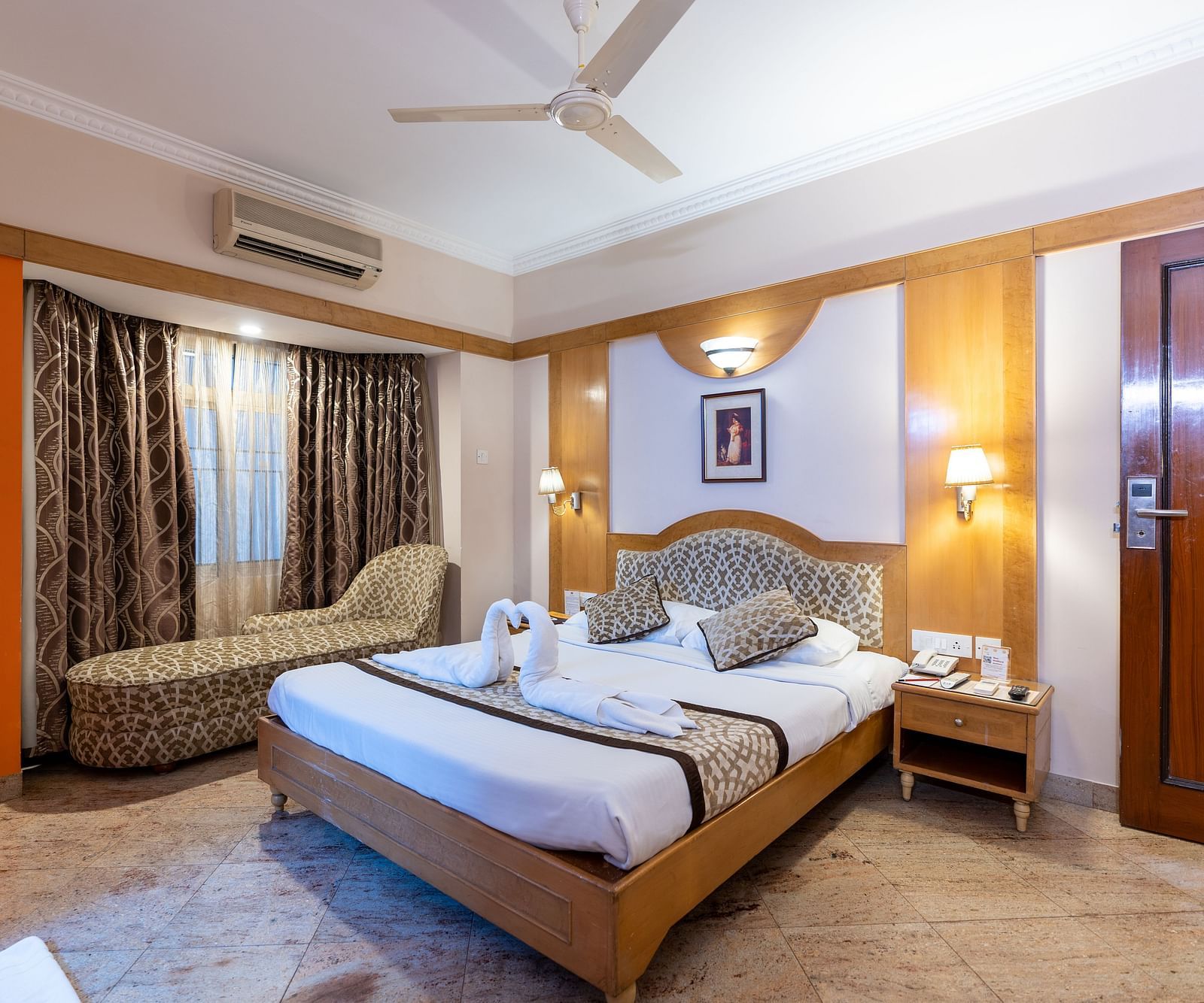a double bed with a lamp above it inside one of the rooms - Hotel Pai Comforts, JP Nagar
