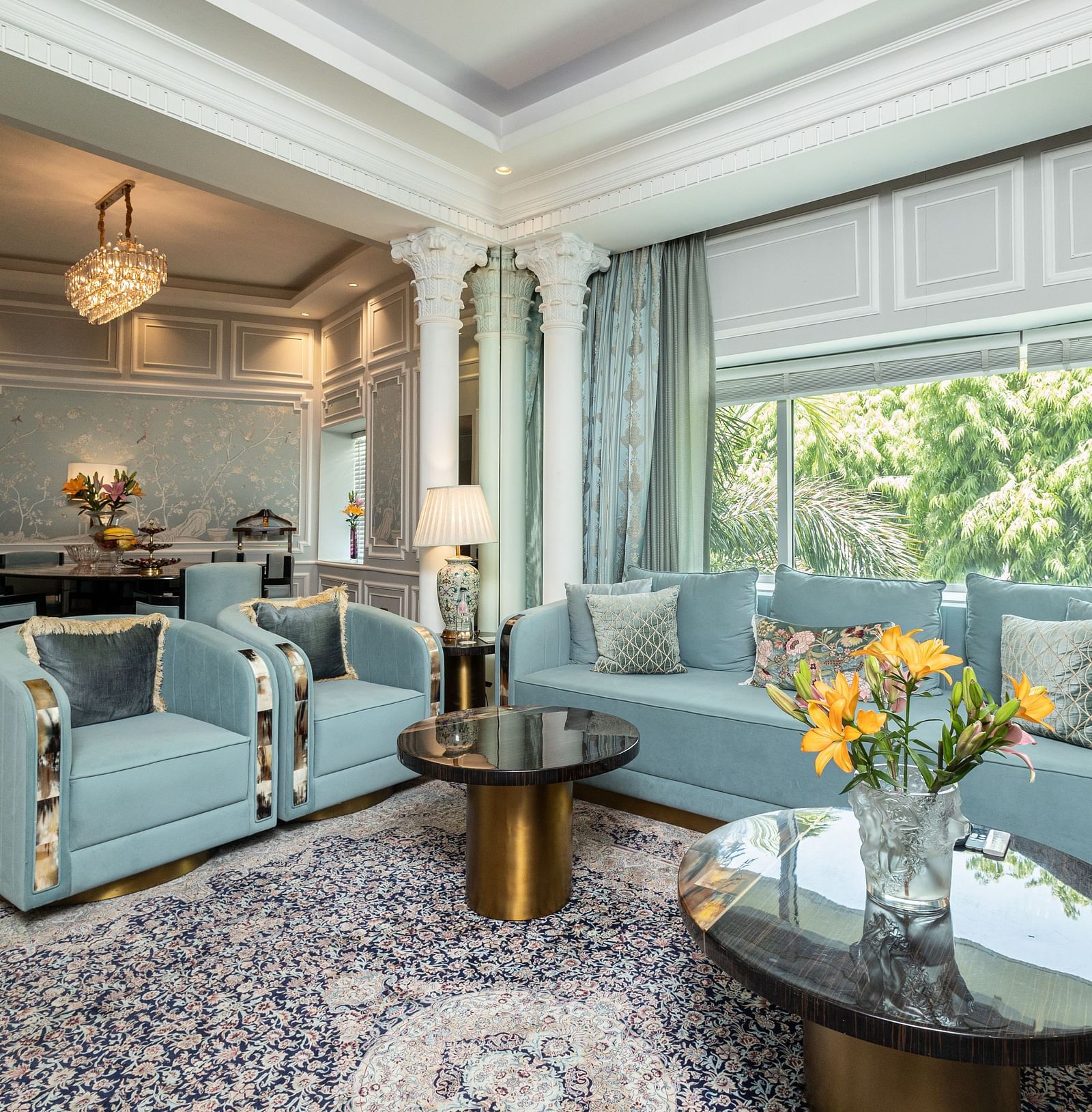 An image of the living area in our Diplomatic suite room with blue couches for comfort and elegance - The Claridges New Delhi