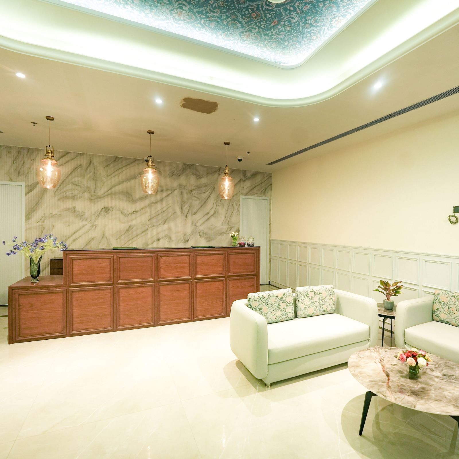 A modern reception area with sleek white sofas and a minimalist vibe - NAMAMI BY ZENQ BANKHANDI