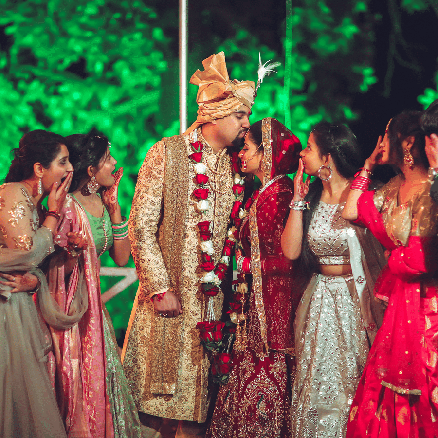 a groom kissing his bride on the forehead at the best wedding venues in south goa