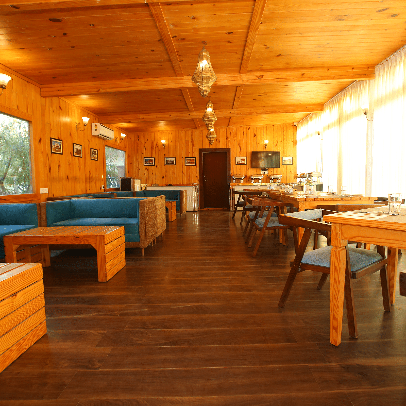 Dining area featuring a large, cozy sofa with a table in front at Aanandam Resort & Spa