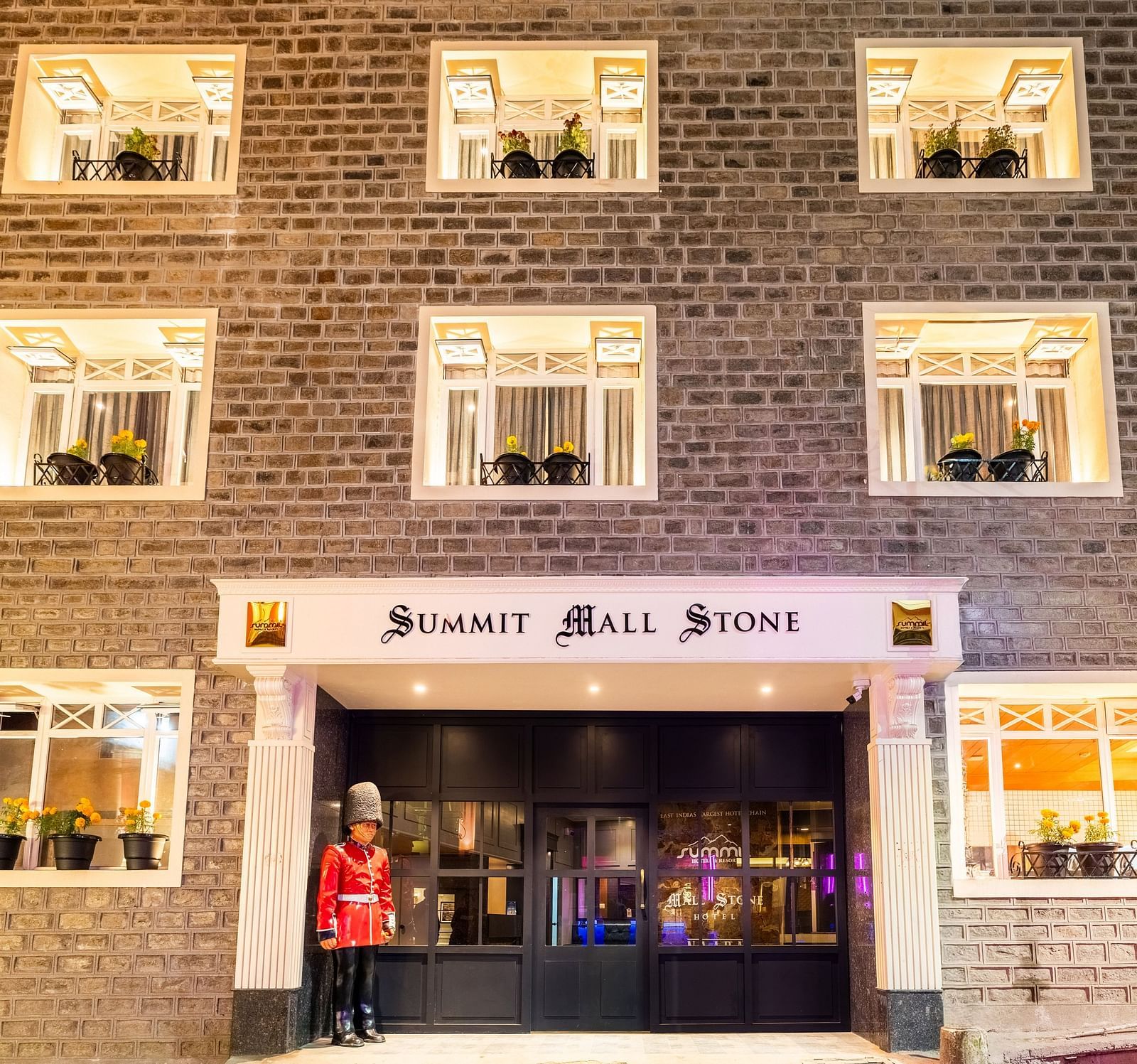 Front view of Summit Mall Stone Hotel, Darjeeling, showcasing room corridors with a distinctive block design