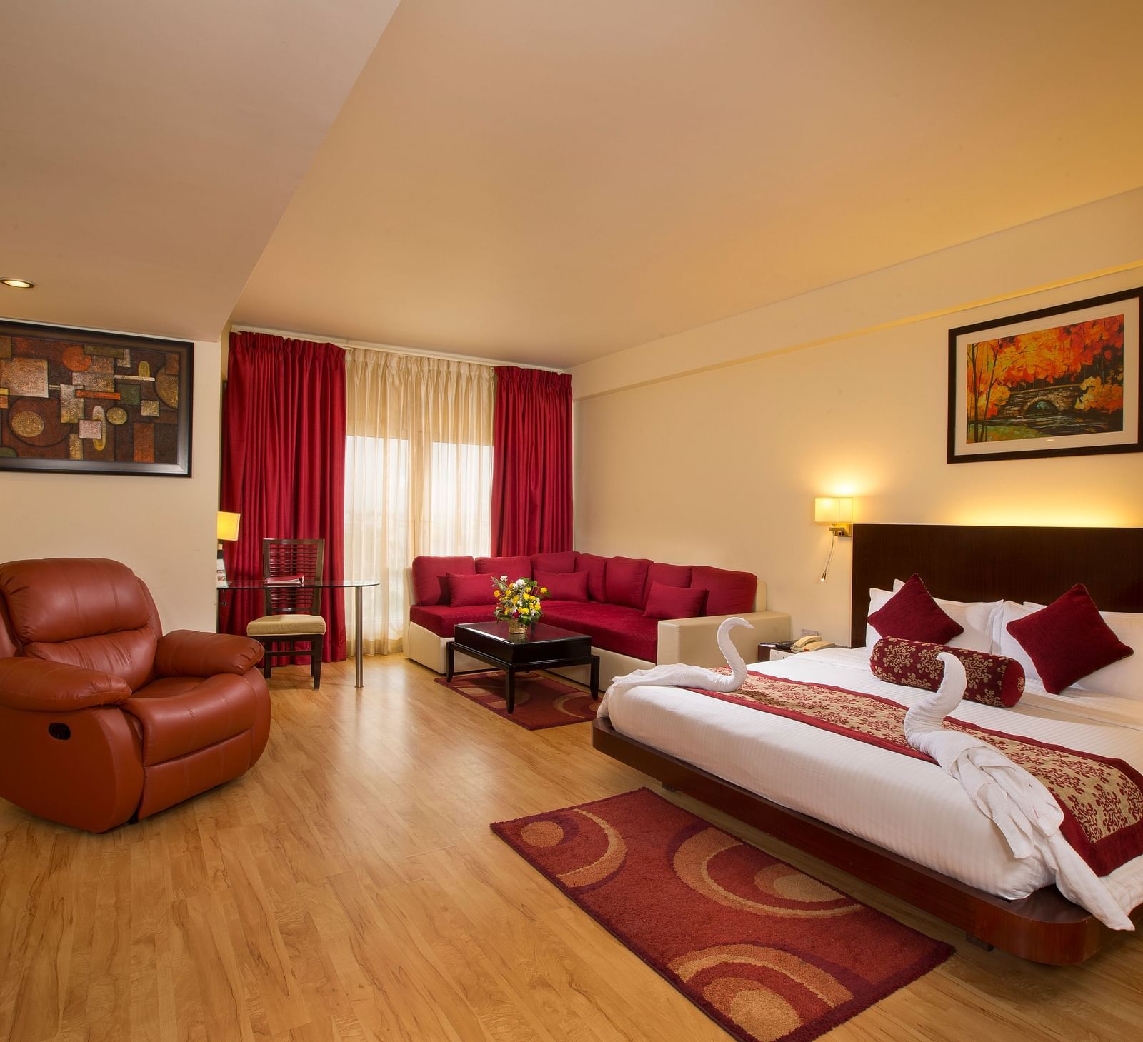 Family Suite decked with a bed, a sofa and a recliner overlooking a window at Logo of Hotel Atithi - TGI Grand, Pondicherry