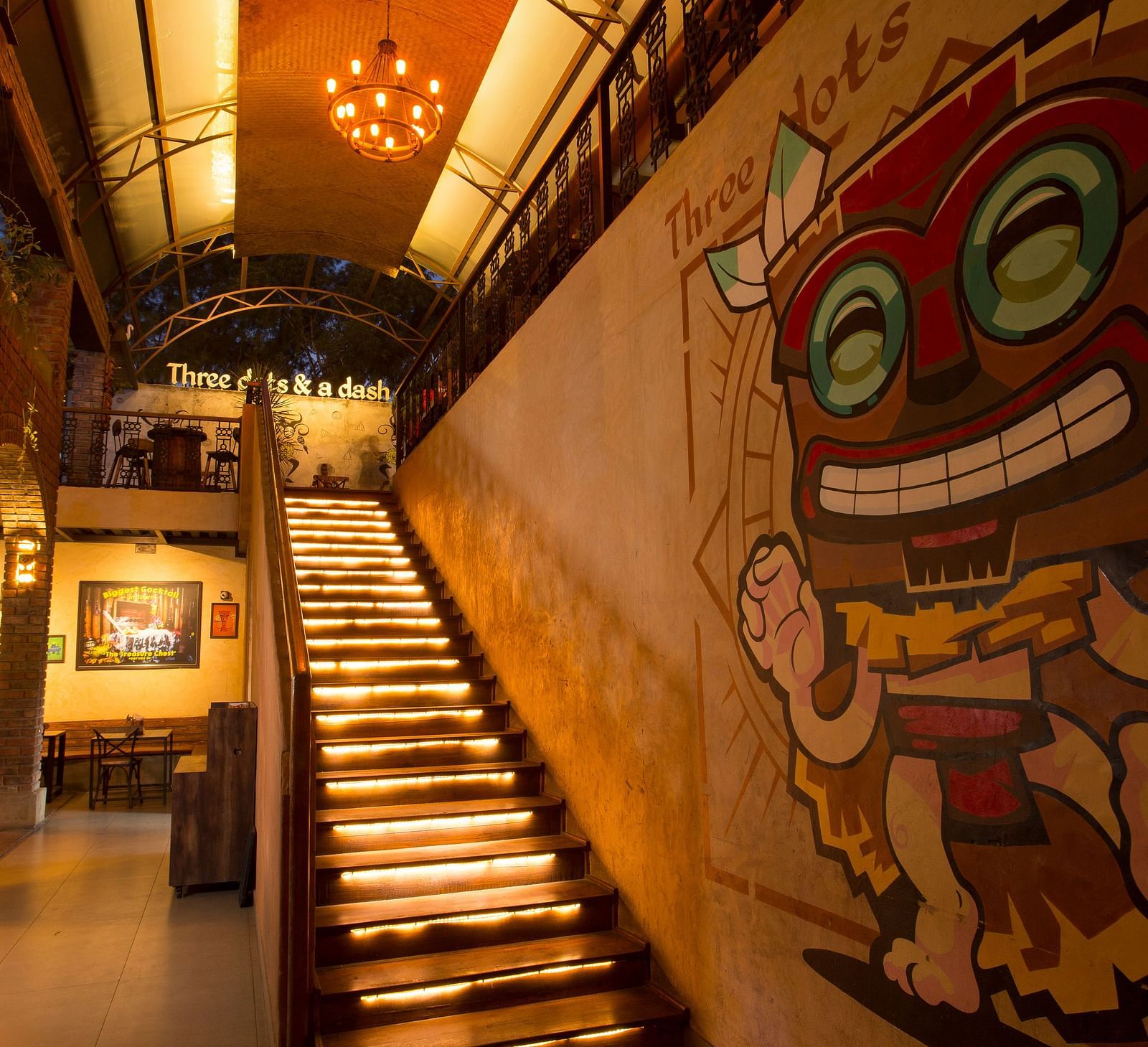 a staircase leading upstairs with graffiti on the wall beside the staircase - Hotel Fountain Tree By TGI - JP Nagar, Bangalore