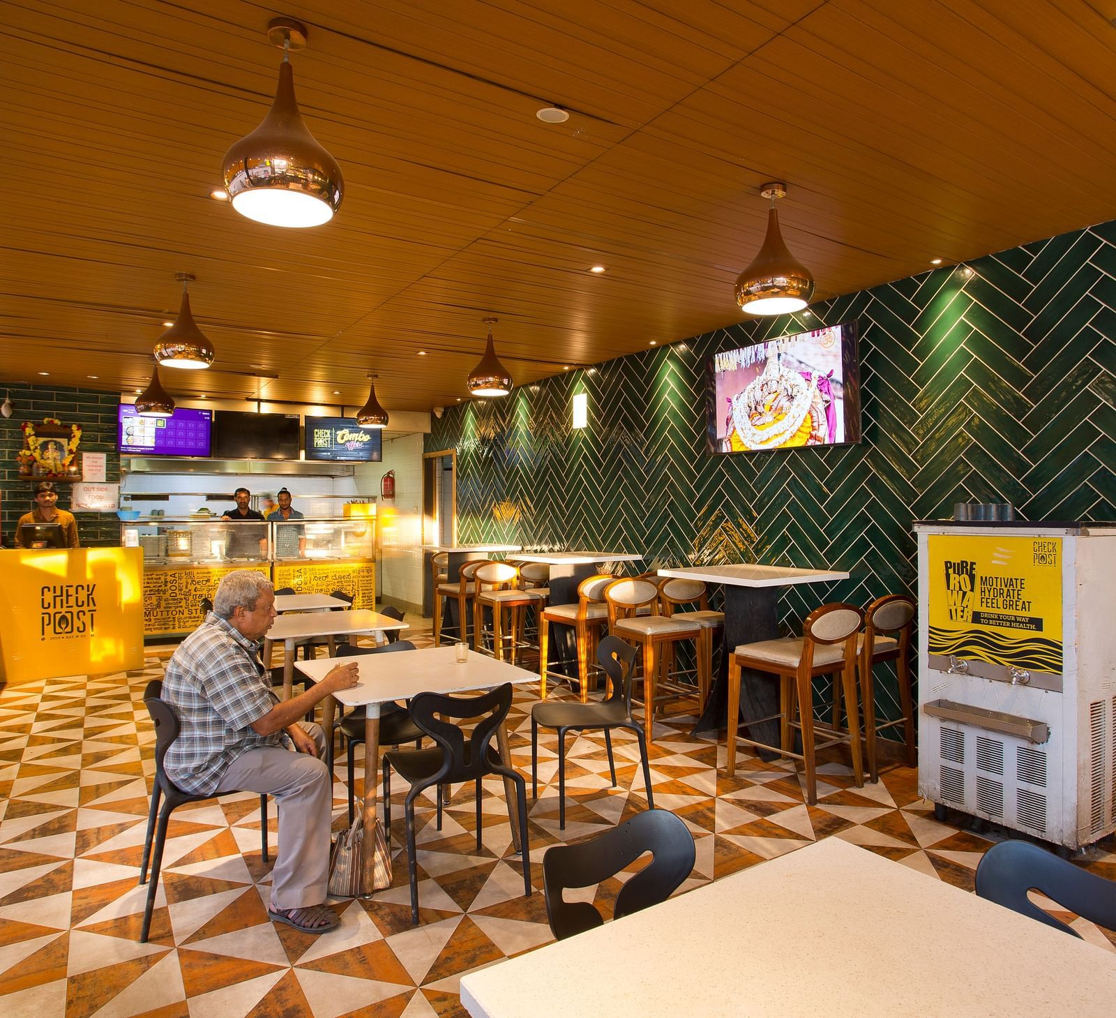 an indoor restaurant with clusters of tables and chairs across the room - Hotel Fountain Tree By TGI - JP Nagar, Bangalore