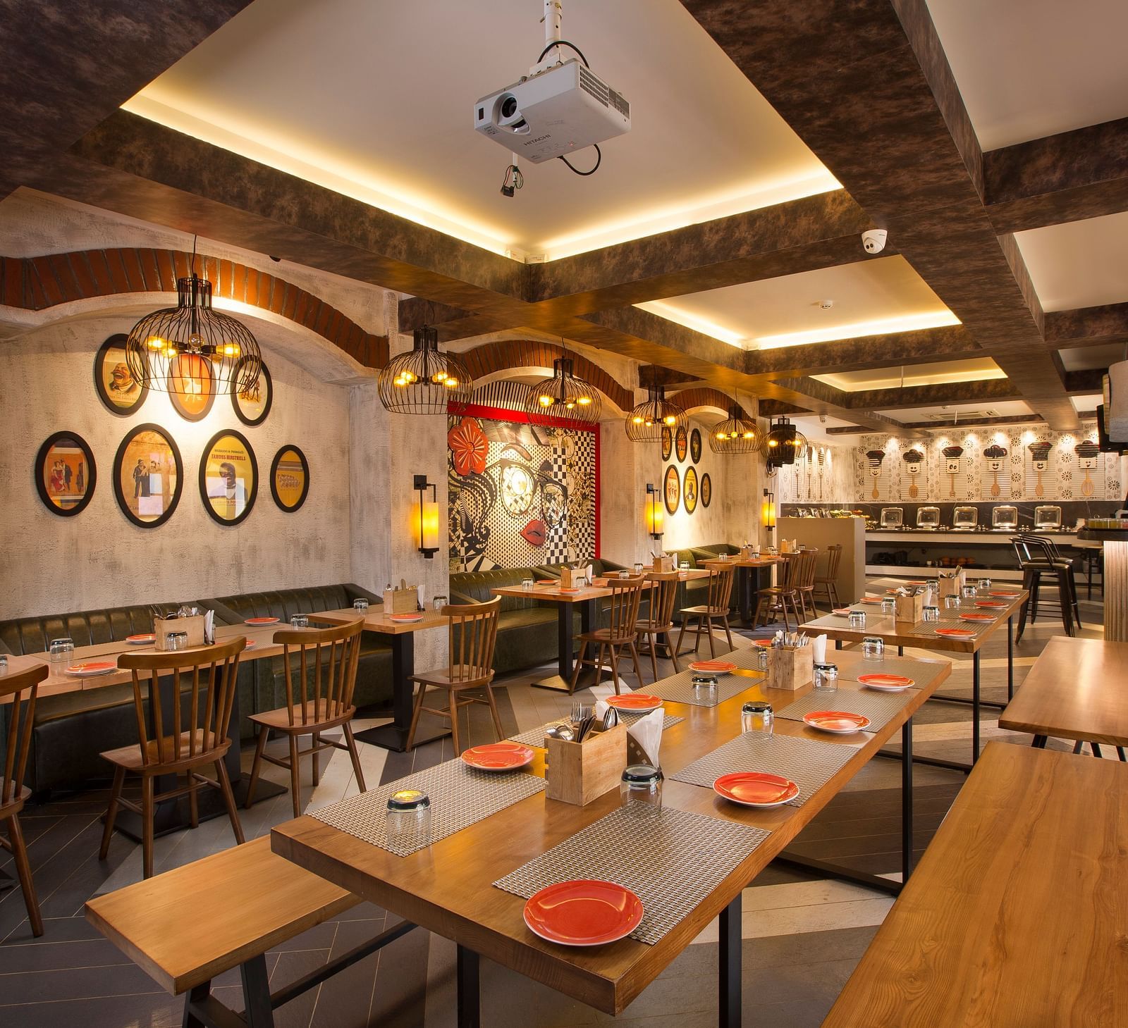A cosy restaurant interior with wooden tables, pendant lighting and a buffet area in the background - Hotel Southend by TGI - Bommasandra, Bangalore
