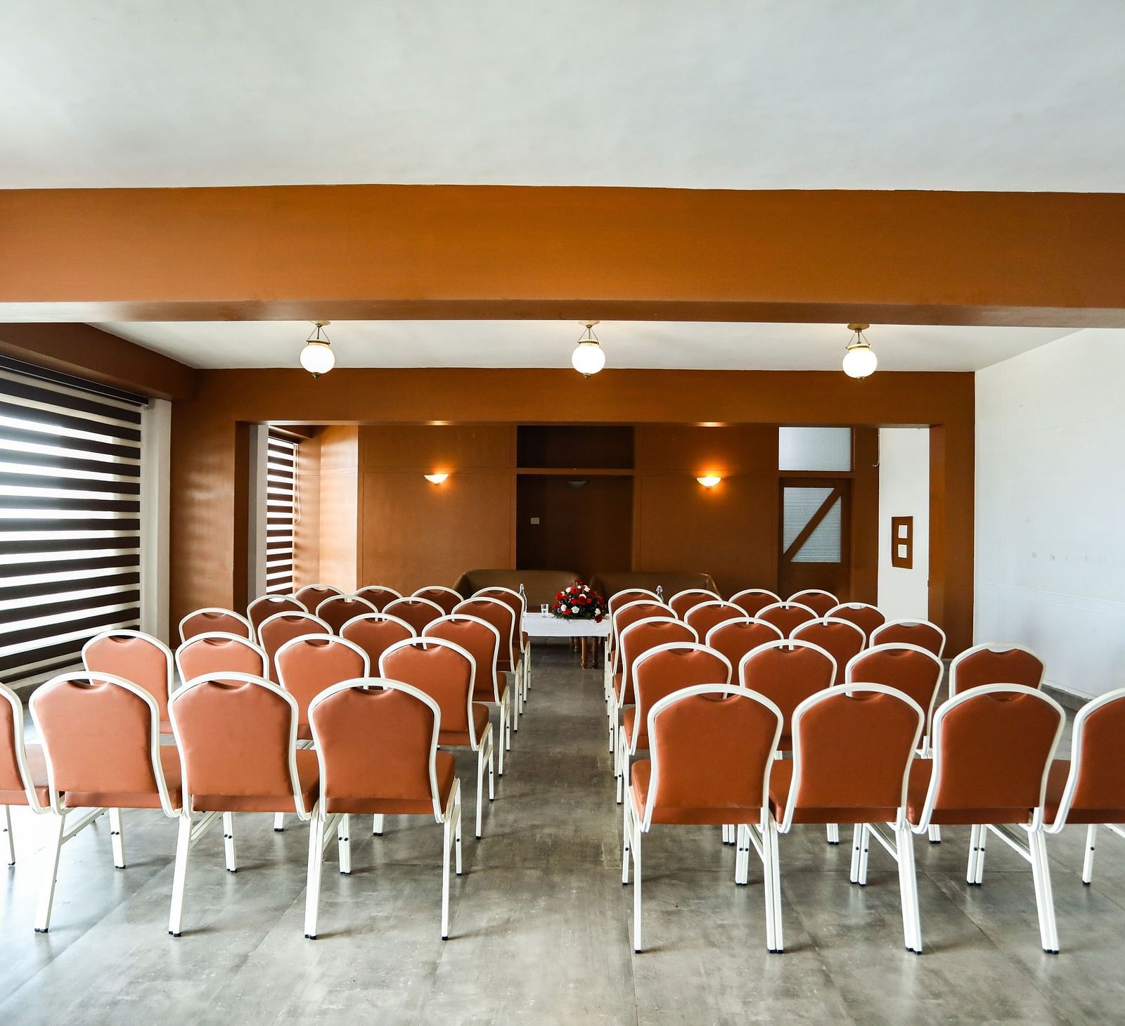 brown and white chairs placed in the banquet hall of La Montana By TGI, Ooty