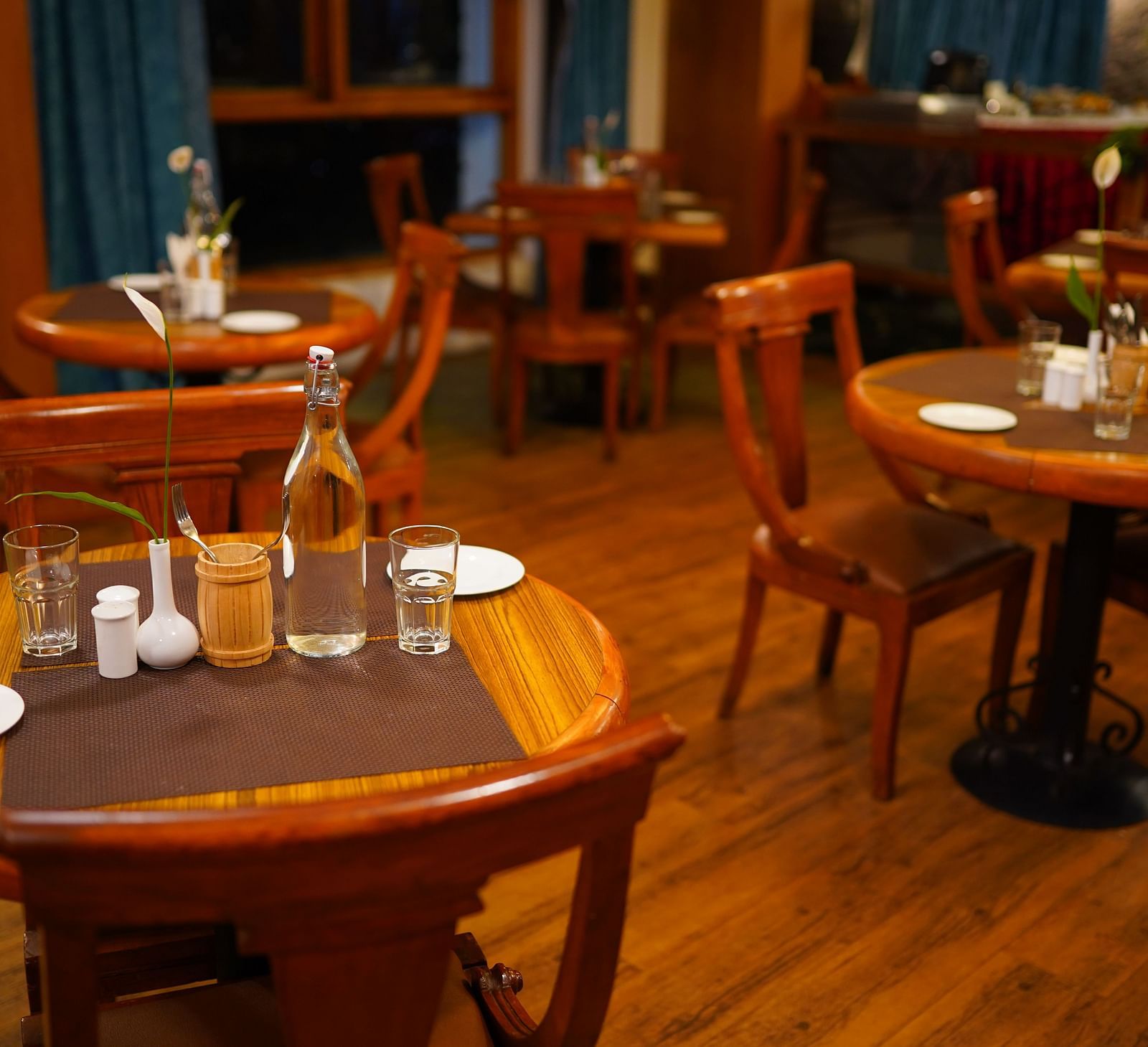 a view of dining table featuring clear plates and water bottles at La Montana By TGI, Ooty