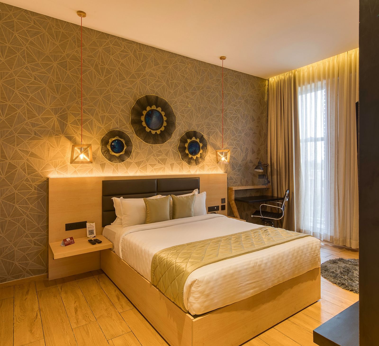 A double bed with golden bedsheets at Sumo Suite at Le Foliage by TGI, Bangalore