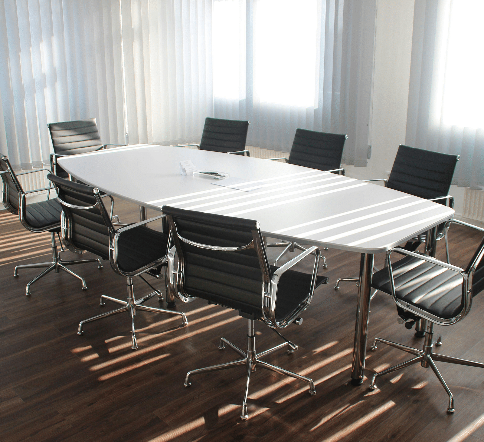 An image of a boardroom with chairs and a table