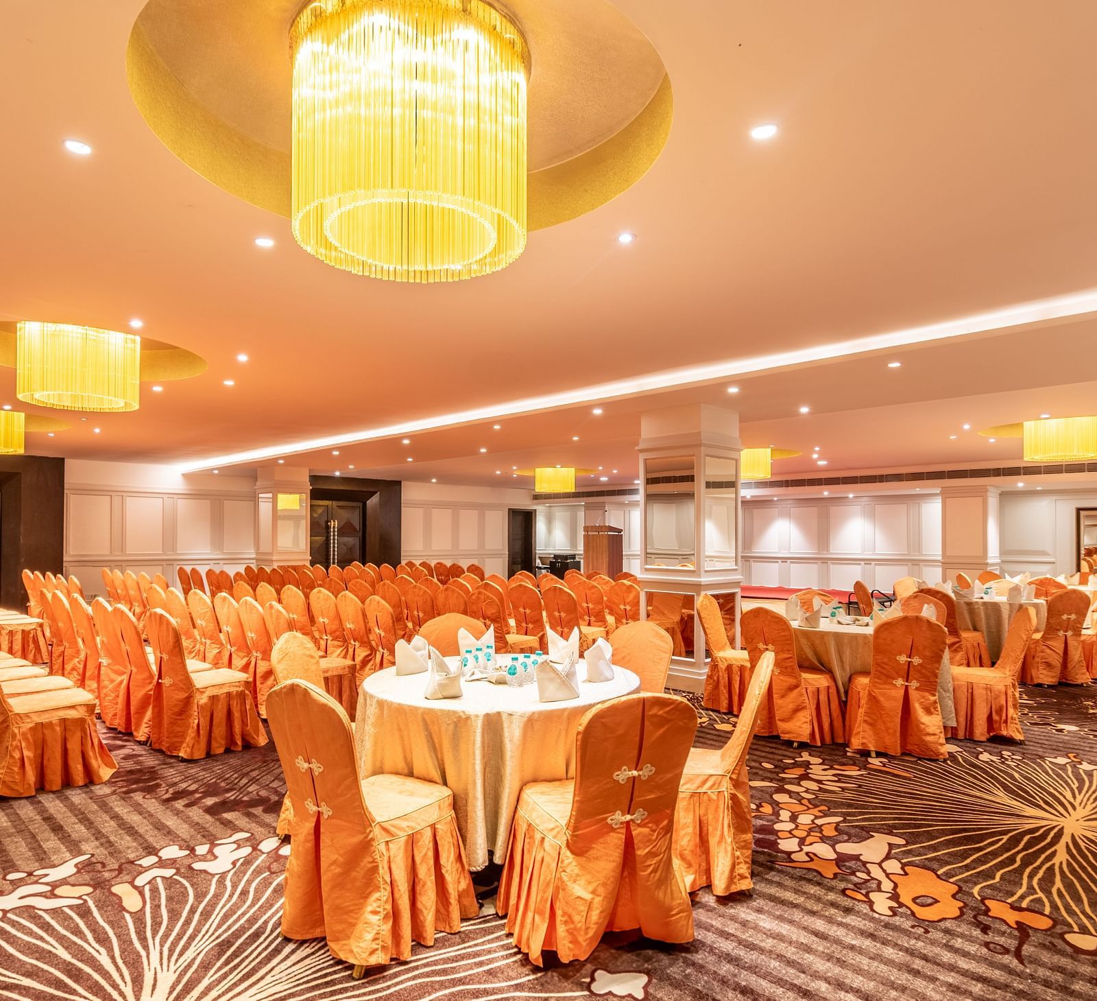 Banquet hall with round tables dressed in satin covers, perfect for a celebratory gathering
