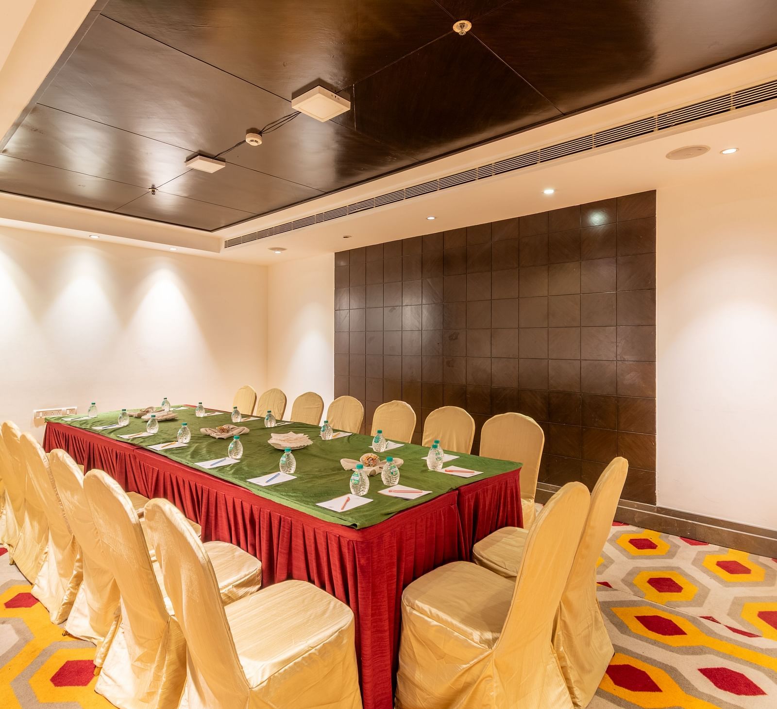 Compact meeting room with U-shaped table arrangement and vibrant carpet flooring- TGI Grand Fortuna, Krishnagiri Main Road, Hosur