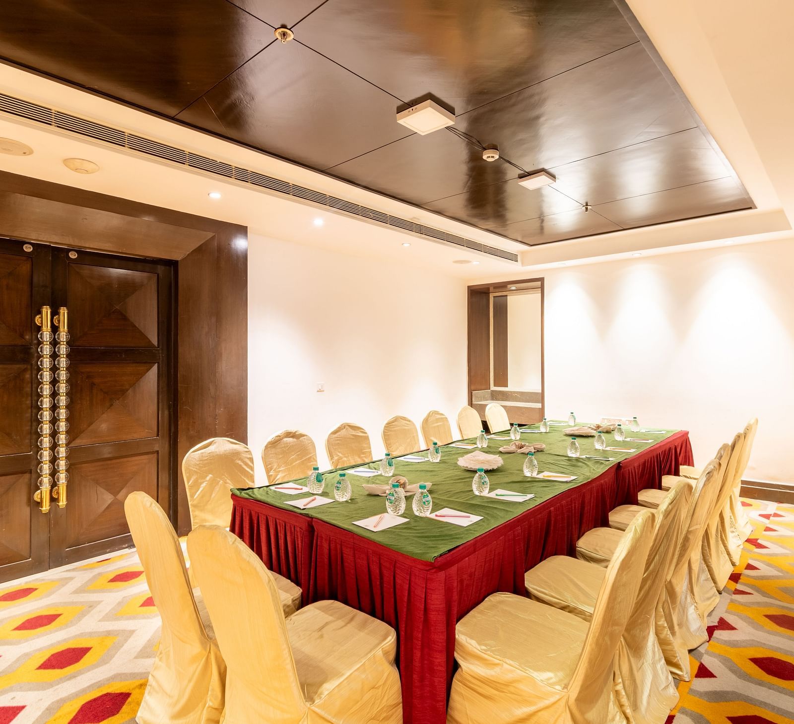Professional boardroom setup with elegant wood paneling and plush seating- TGI Grand Fortuna, Krishnagiri Main Road, Hosur