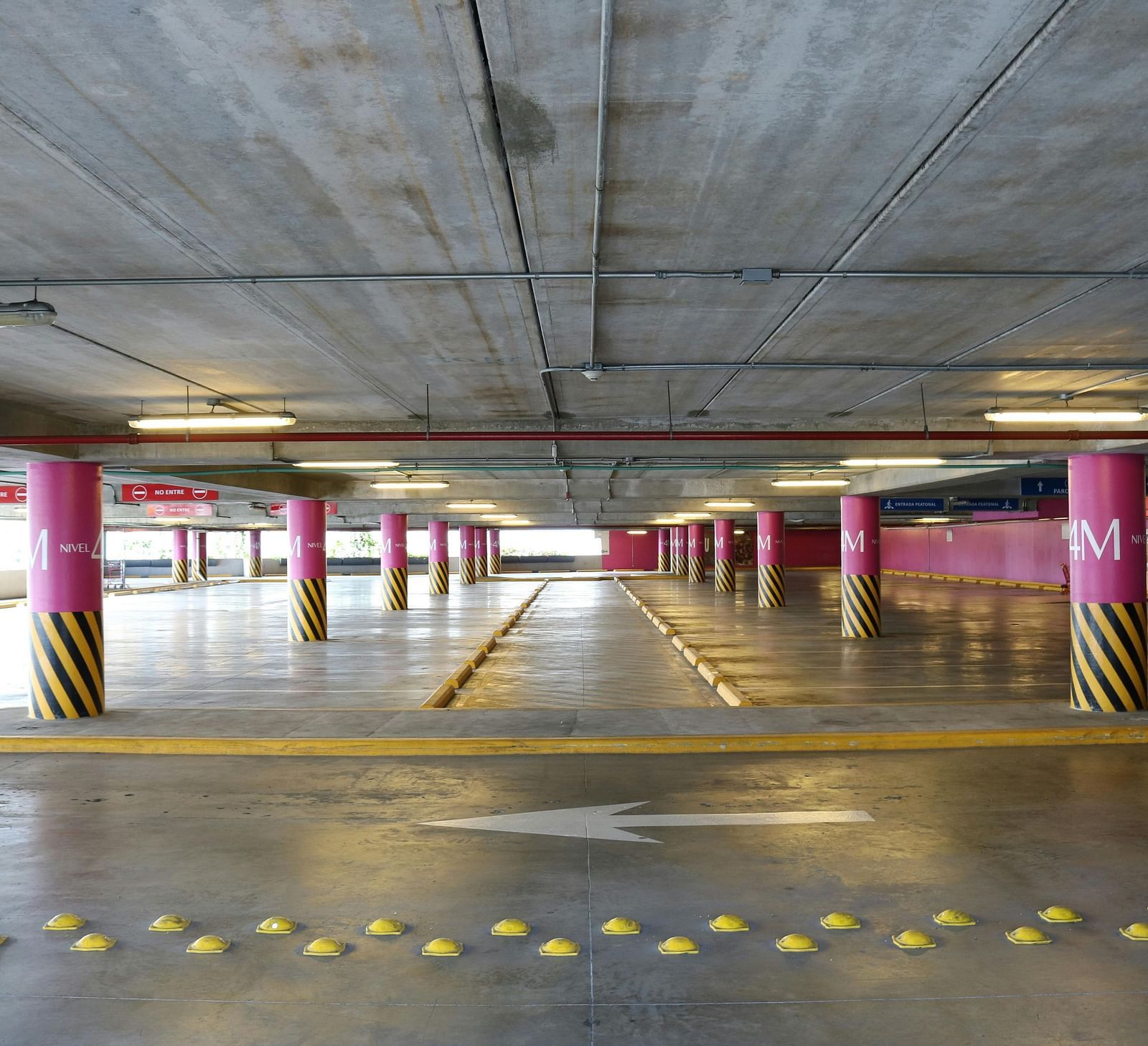 image of a spacious parking space with arrows printed on the floor