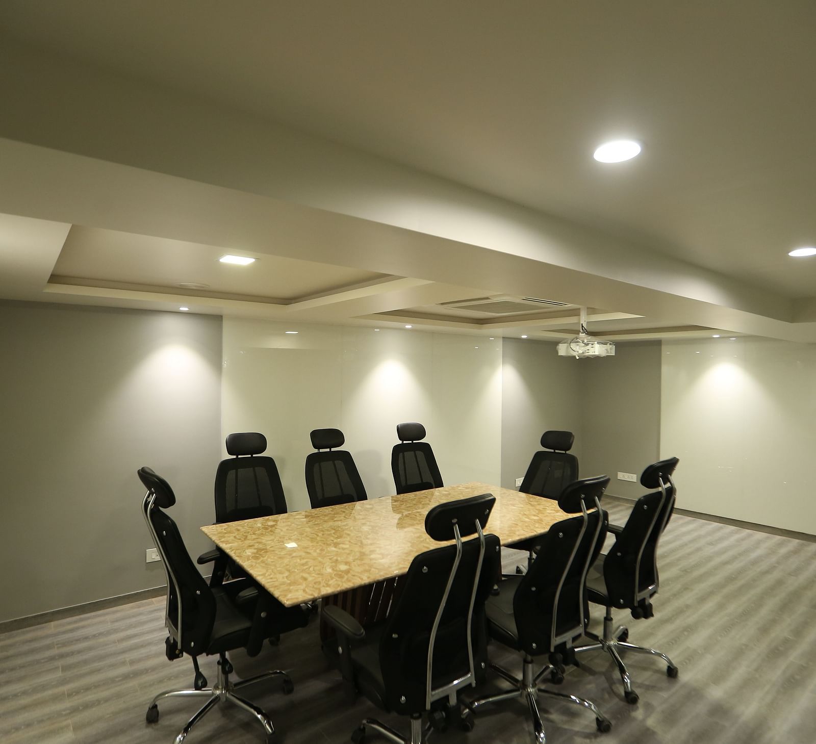 A meeting room setup with a long conference table and chairs - TGI SPS Grand, Coimbatore