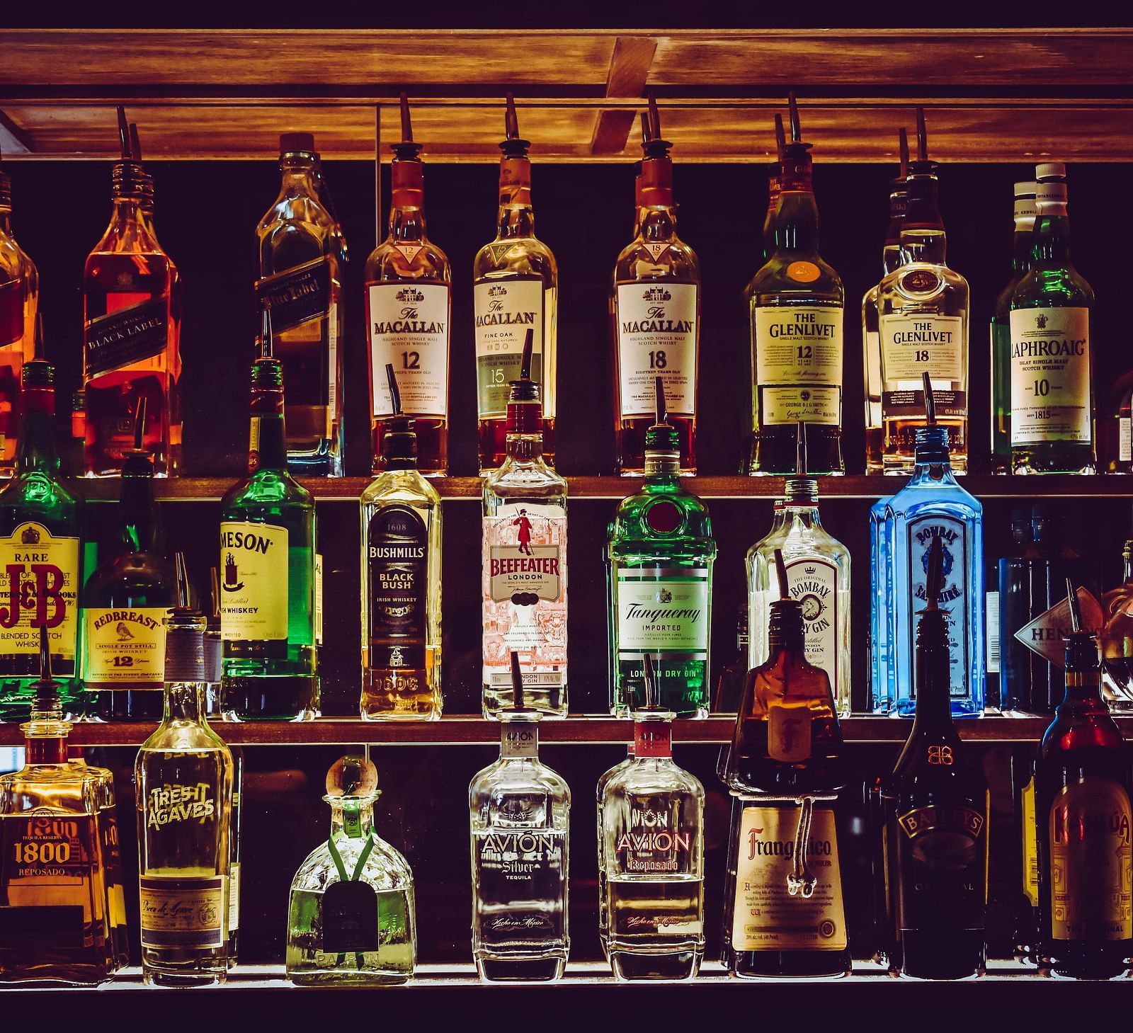 An assortment of wine bottles placed on the counter.