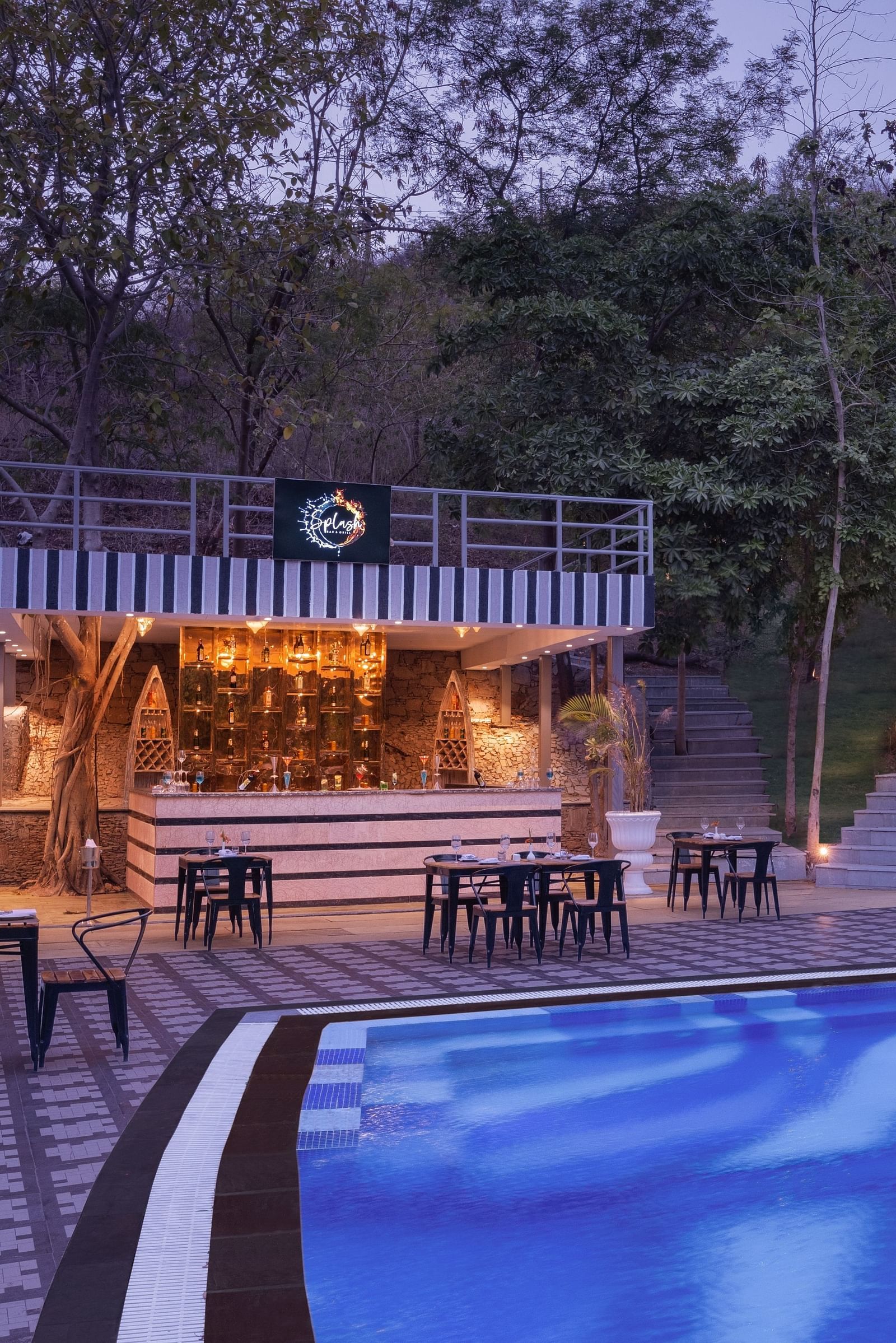 An overview of the seating inside Splash Bar Grill next to the swimming pool - Essentia Luxury Resort & Spa, Udaipur.