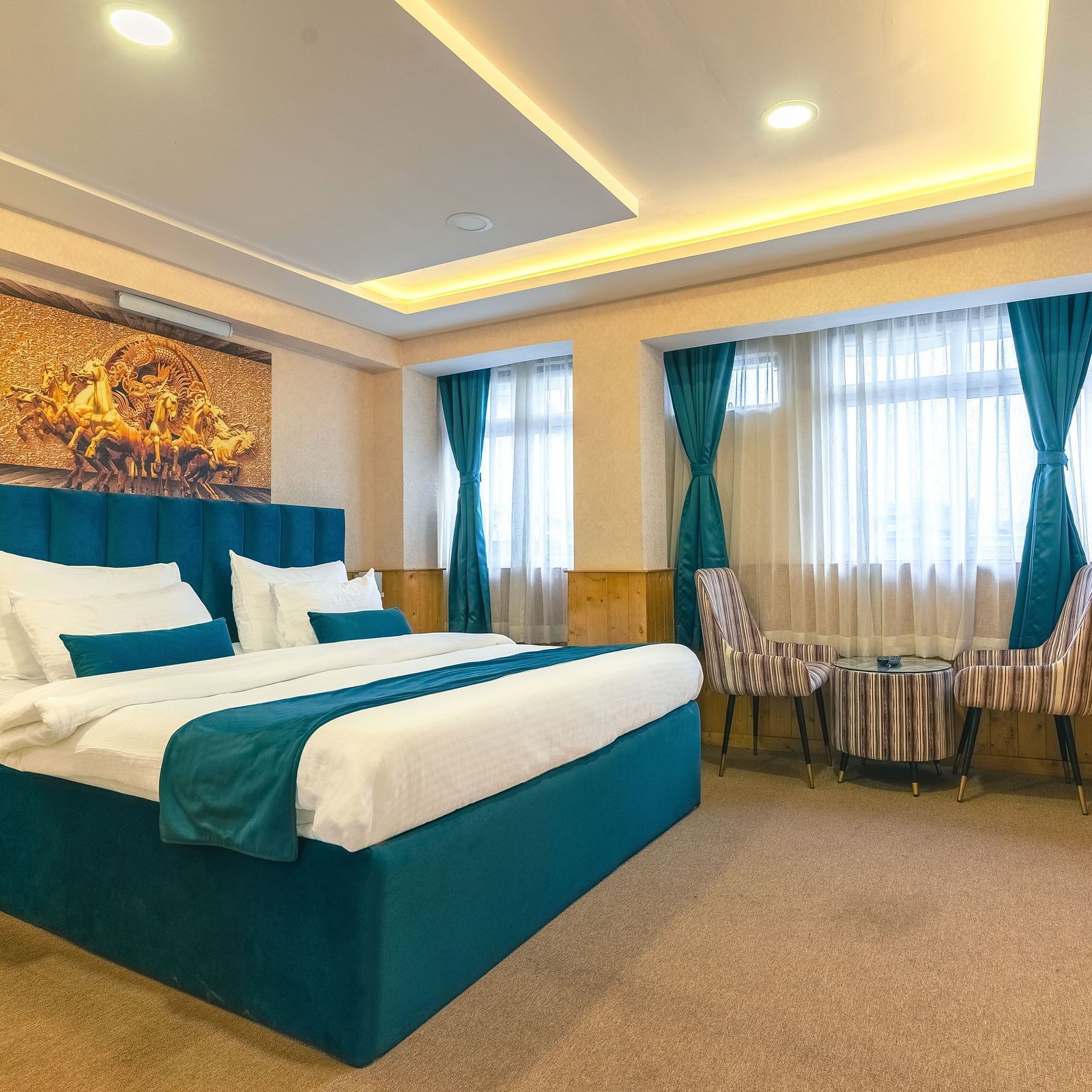 Deluxe Room Avianna Seven Seas, Deluxe Room with a king size bed, inviting ambiance, wooden bedside table, and a large window with curtains drawn along with a wall mounted television at Avianna Seven Seas, Darjeeling.