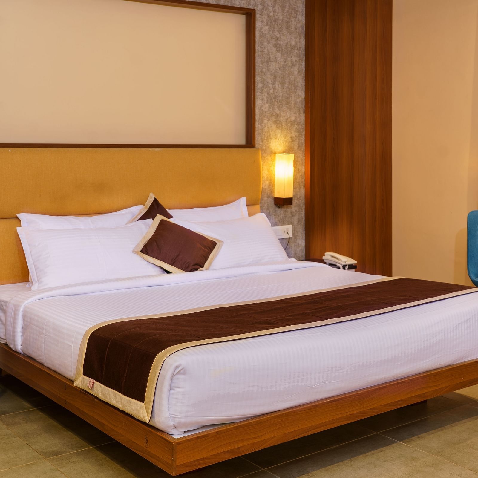 Room with bed and chair with table at Wyt Hotels, Rameswaram