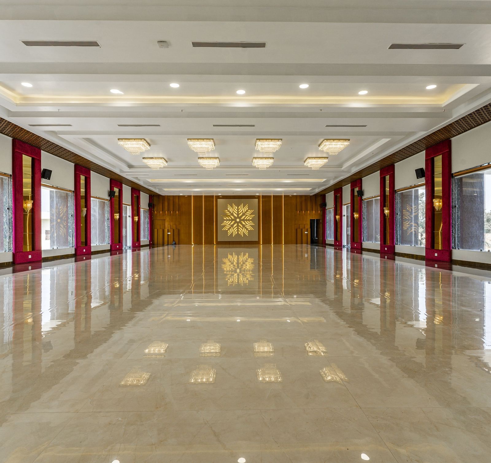 A long, empty hallway with a highly polished floor that reflects the ceiling and walls - Bamboo Saa Mulberry Resort, Pushkar