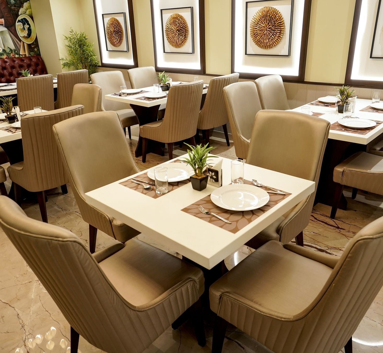 A close-up shot of a 4-seater dining table at the Mosaic restaurant featuring 2 plates on the table.