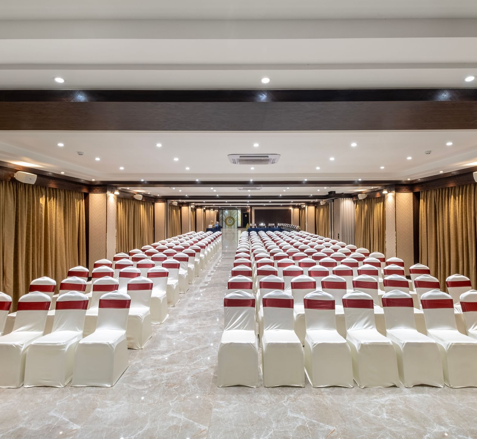 Theatre seating arrangement with ambient lighting at Monday Hotels Amalapuram Heights banquet hall.