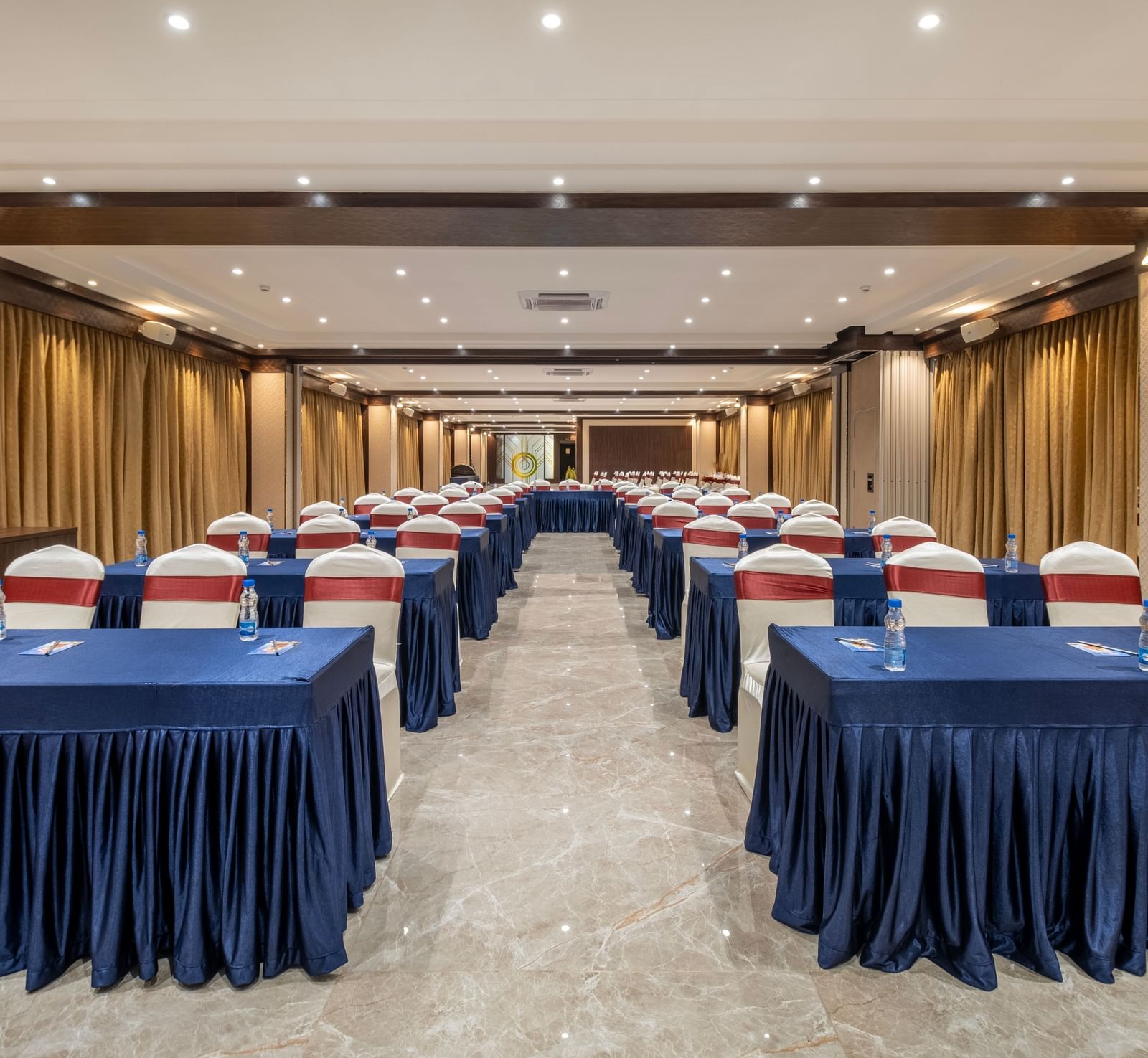Spacious hall at Monday Hotels Amalapuram Heights with classroom seating arrangement.