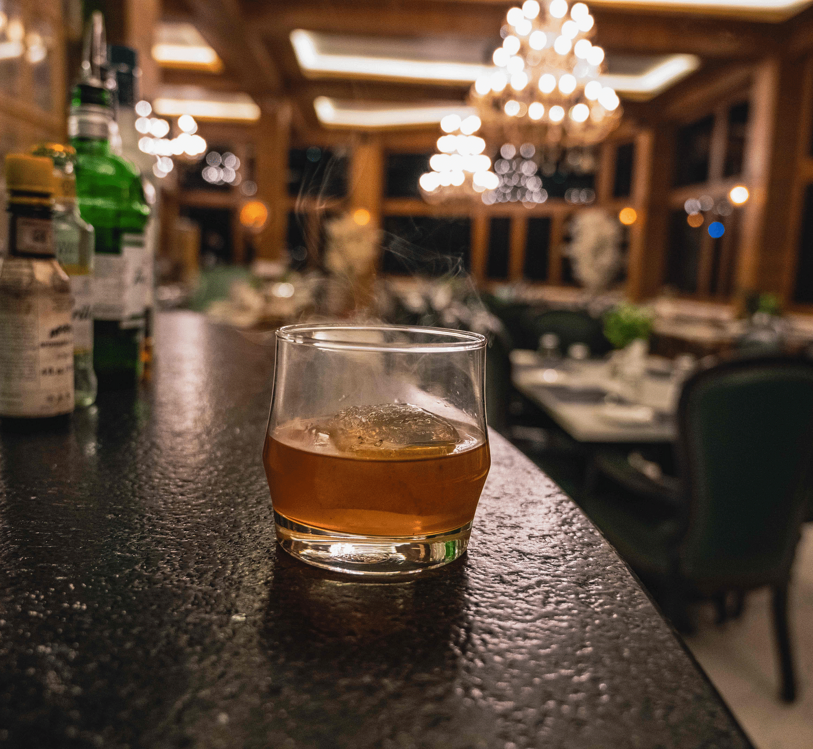 image of a drink served in a glass kept on a black platform at the alpenrose restaurant - the tattva boutique resort