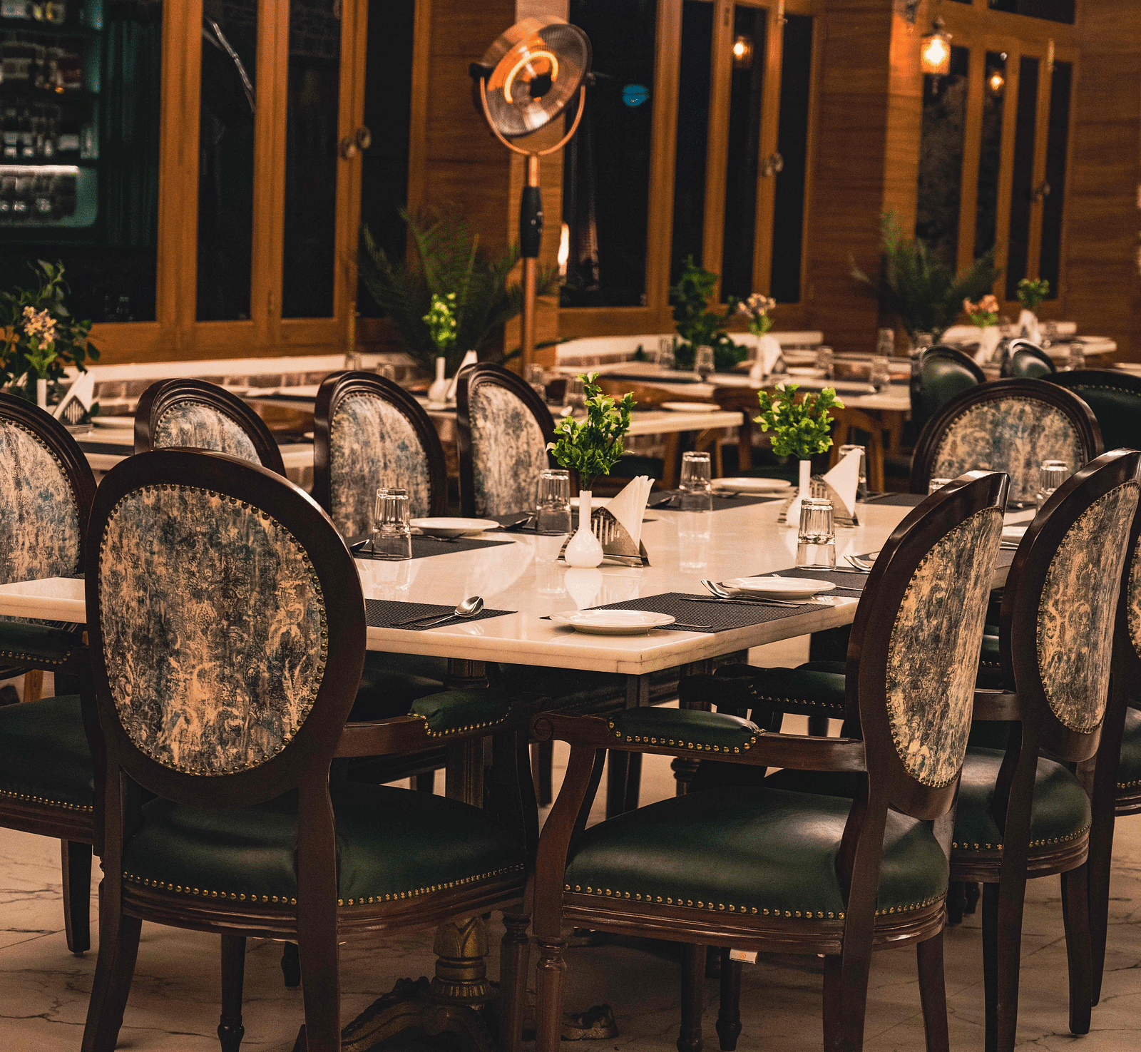 image of the alpenrose restaurant featuring an elegant dining table with well placed cutlery - the tattva boutique resort