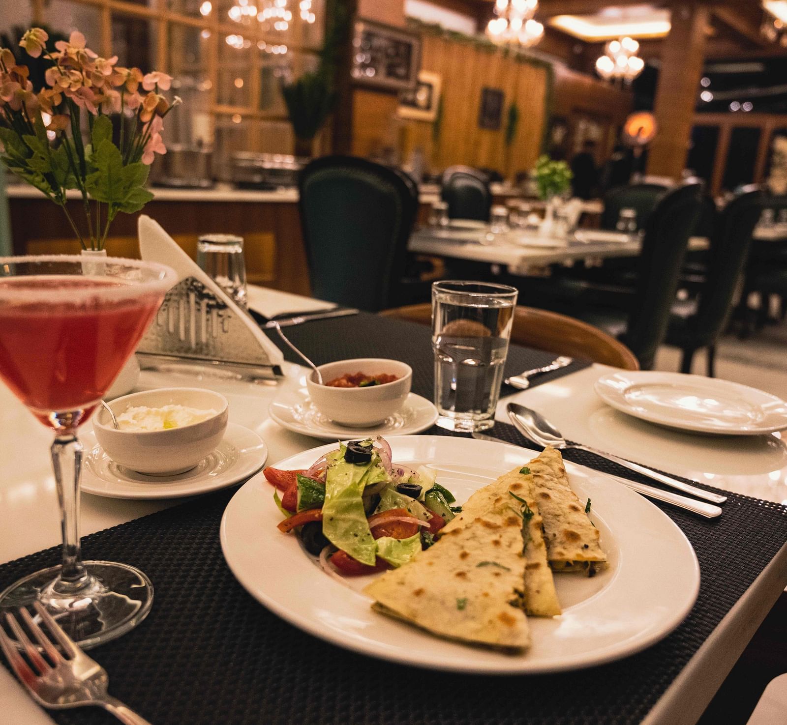image of food served on a white plate with salad served with a red coloured beverage - the tattva boutique resort
