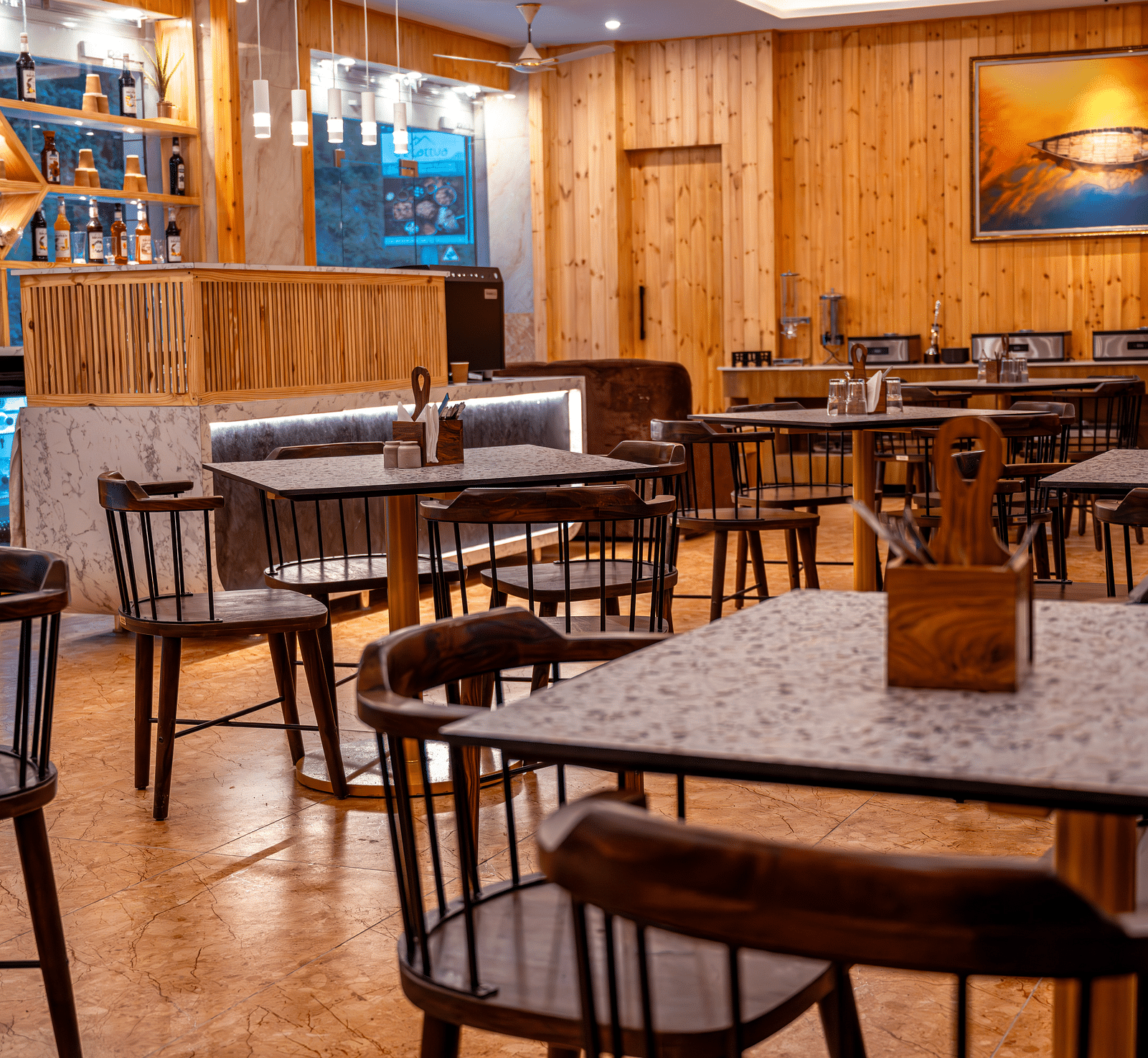 Image of the in-house restaurant featuring a fine dining setup, natural  lights and a coffee machine | The Tattva Devprayag