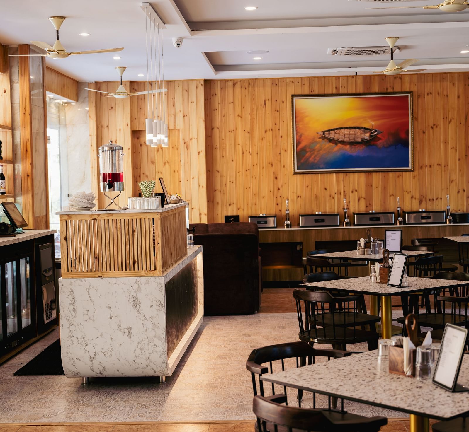 Image of a part of restaurant featuring the bar section and some vacant tables | The Tattva Devprayag
