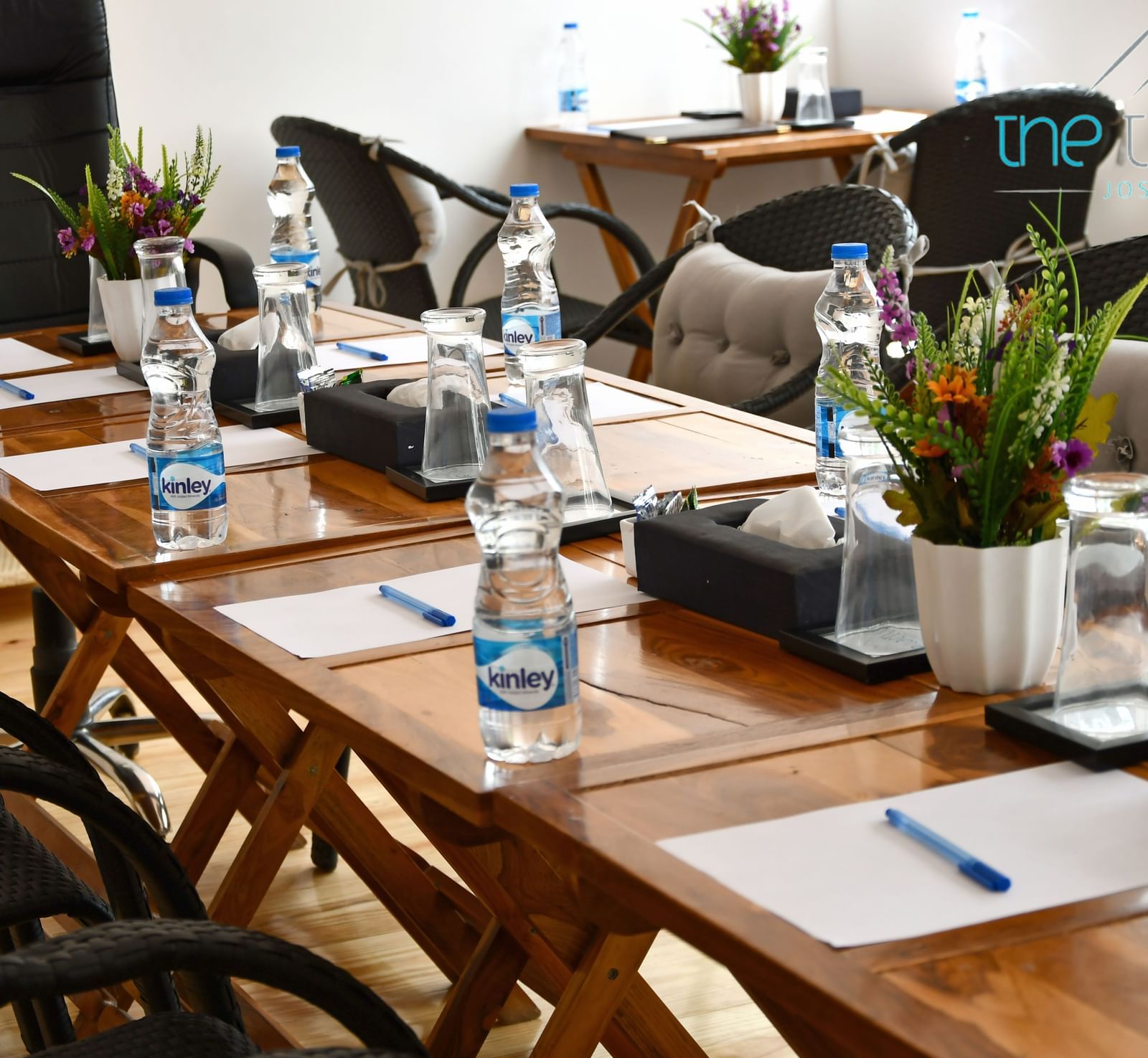 close up image of the table in the conference hall with white sheets kept on the table at the tattva, joshimath