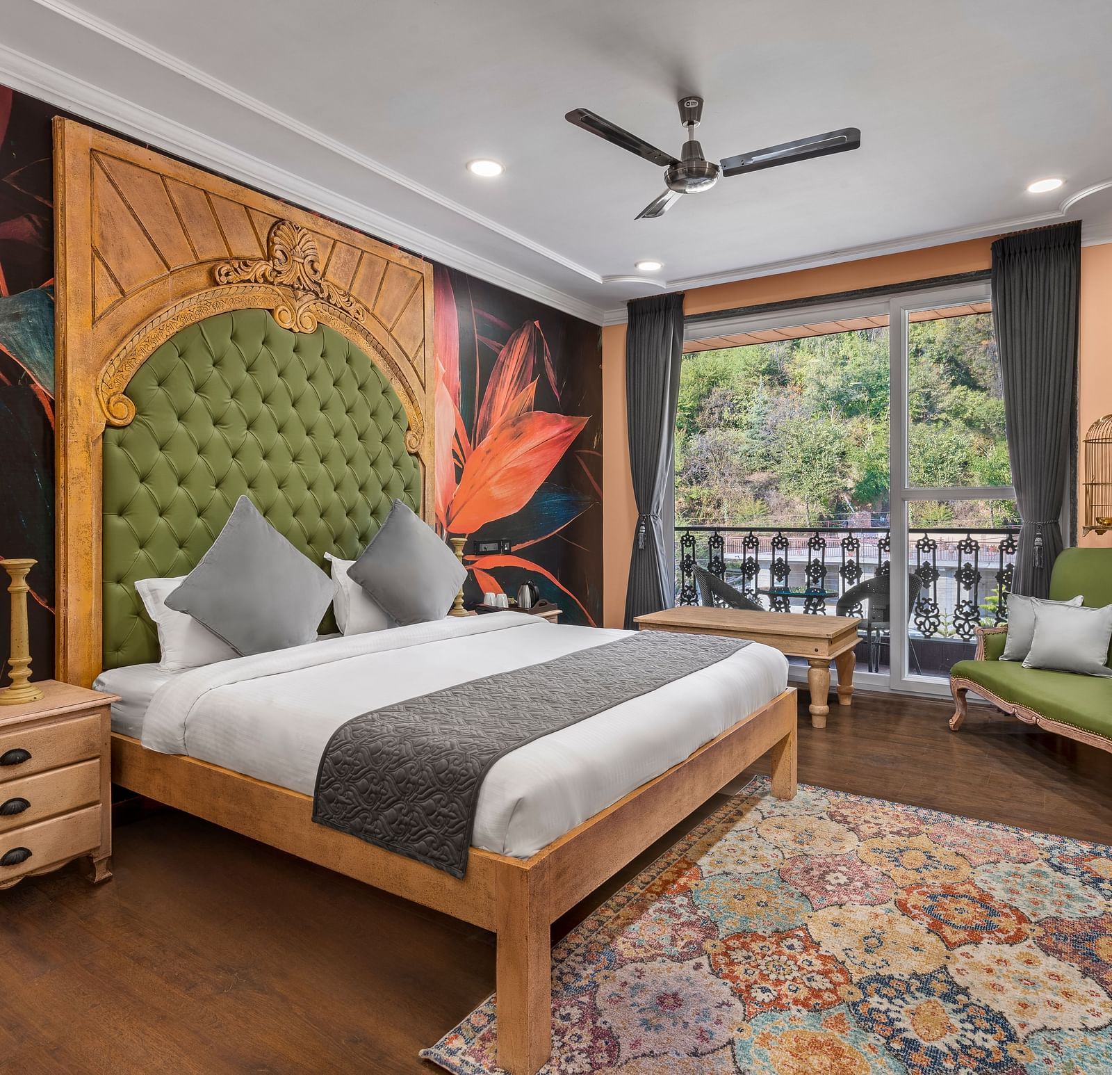 a bedroom with a wallpaper and a large green headrest and large windows leading out into the balcony - Atman, Dharamshala