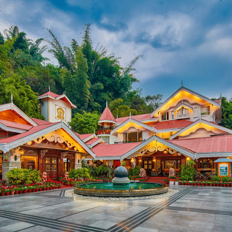 Evening view of the ornate, traditional architecture at MAYFAIR Spa Resort & Casino, Gangtok with warm ambient lighting.