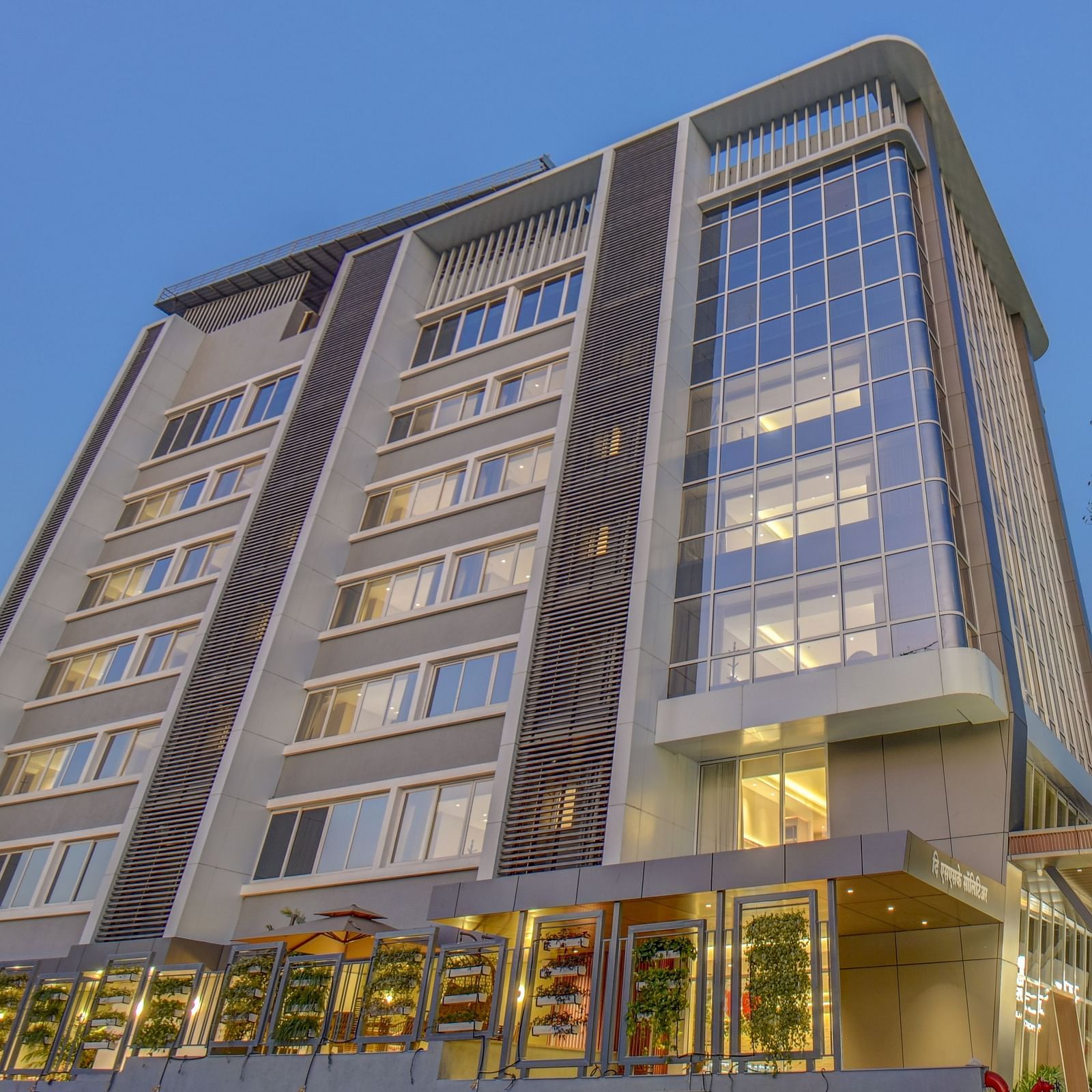Low angle shot of Facade of  The SSK Solitaire Boutique Hotel & Spa, Gangapur Road - Nashik with backdrop of blue sky