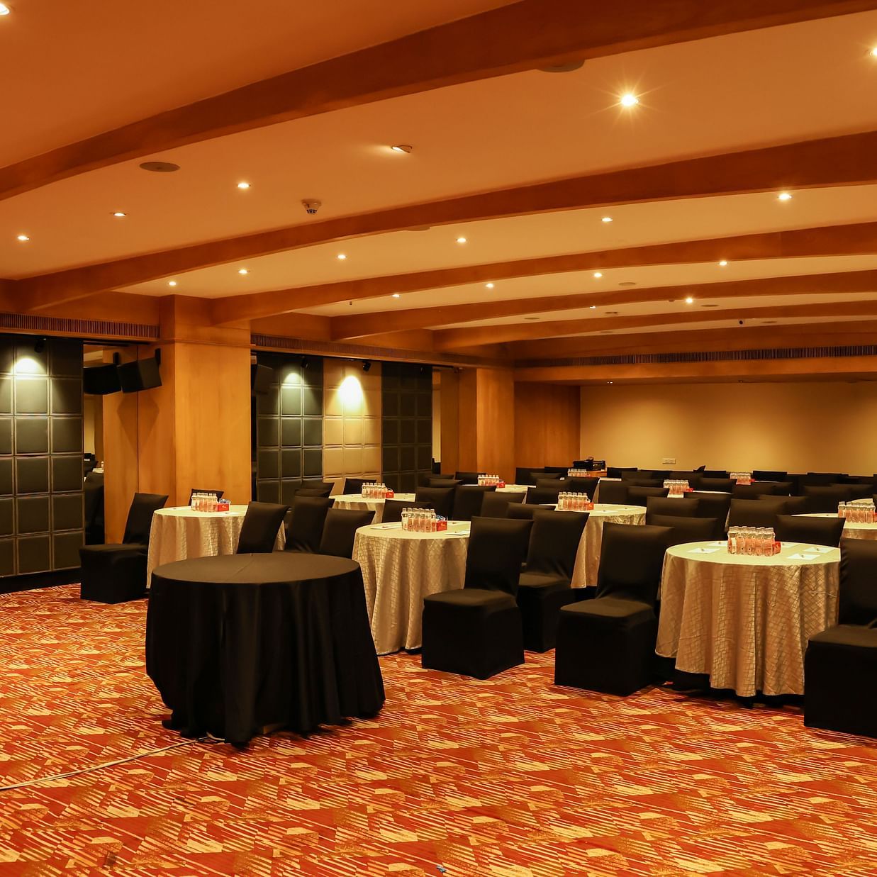 Sesame Hall at The Beatle Hotel, Powai, set up for an event with round tables and ambient lighting.