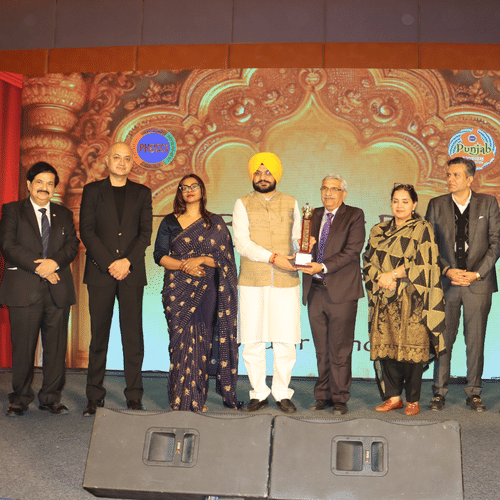 A group of people on a stage with ambient lighting and professional attire during an award ceremony