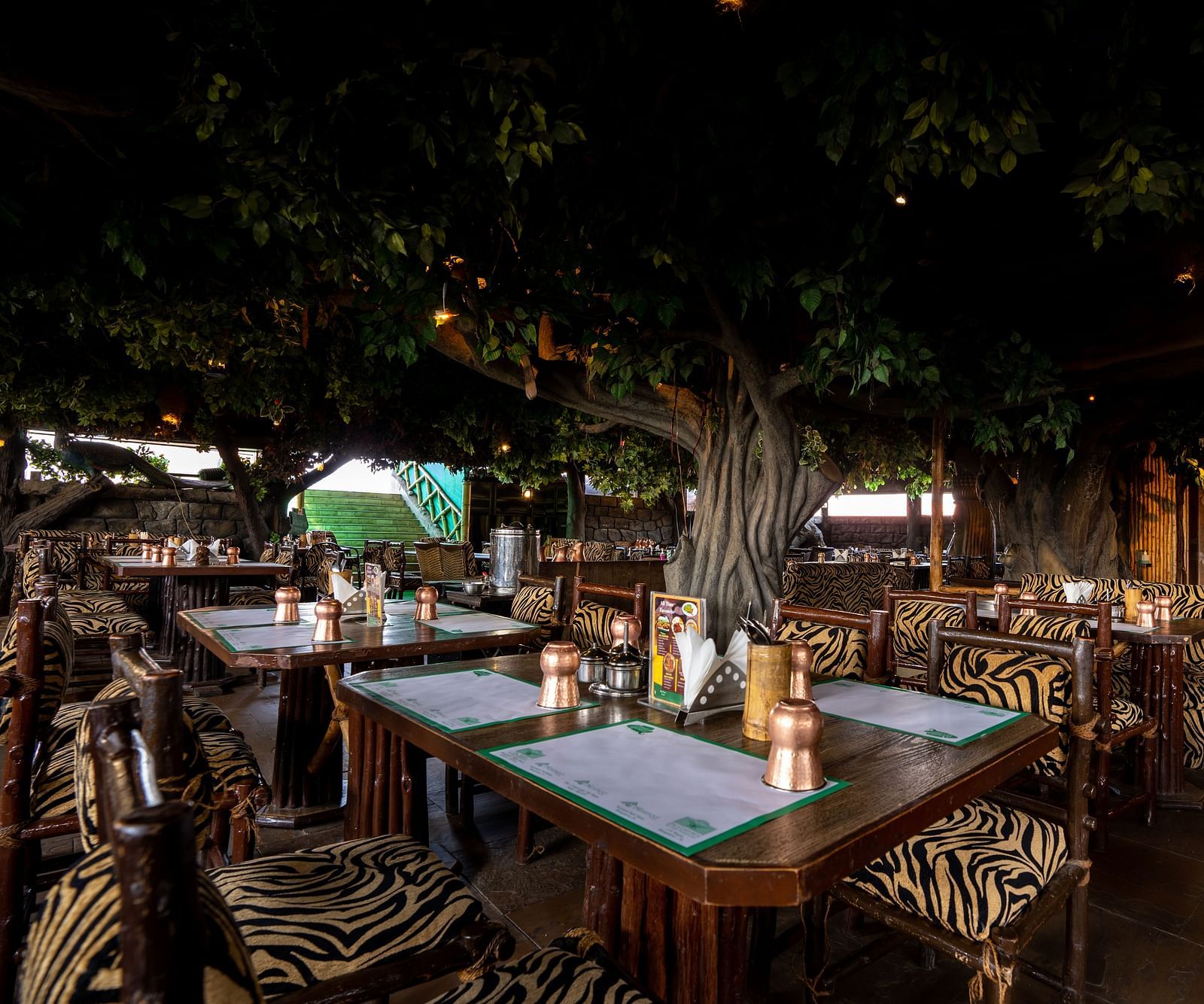 seating arrangements inside one of the restaurants at Hotel Pai Vista, Mysore