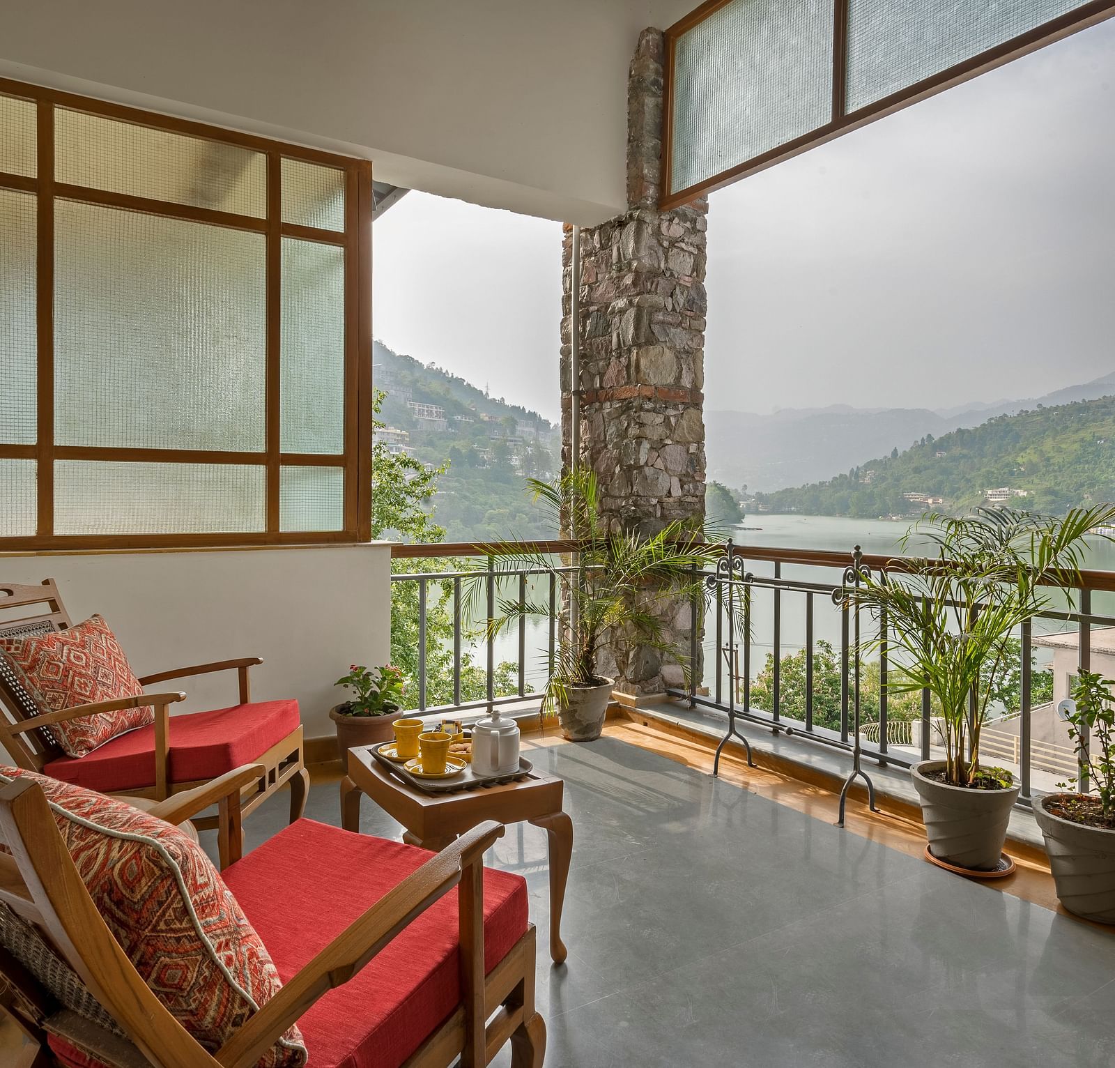 Sitting area with a beautiful view in the Superior Rooms at Fishermen's Lodge, Bhimtal, perfect for enjoying the serene surroundings.