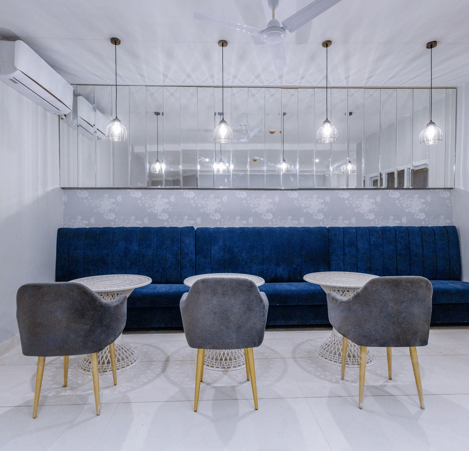 Restaurant area featuring modern chairs and tables against a dark blue wall. - Hotel Downtown17, Chandigarh 