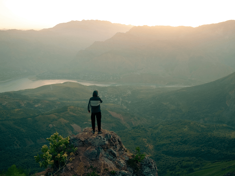 Traveller enjoying sunrise views from a hilltop viewpoint in Kumaon