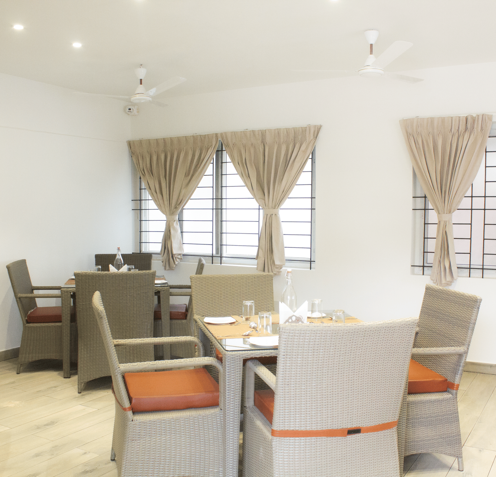 A full-view shot of the Spice and Slice Restaurant with well-arranged dining tables at WOW Naturefull Resorts, Yercaud.